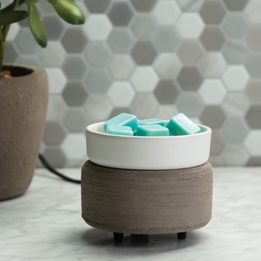 Gray 2 in 1 Melter Using The Wax Melt Portion on a Table in a Home.jpg