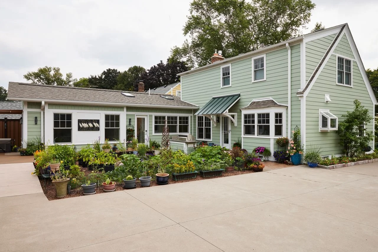 photo of an addition to a home with a backyard garden.