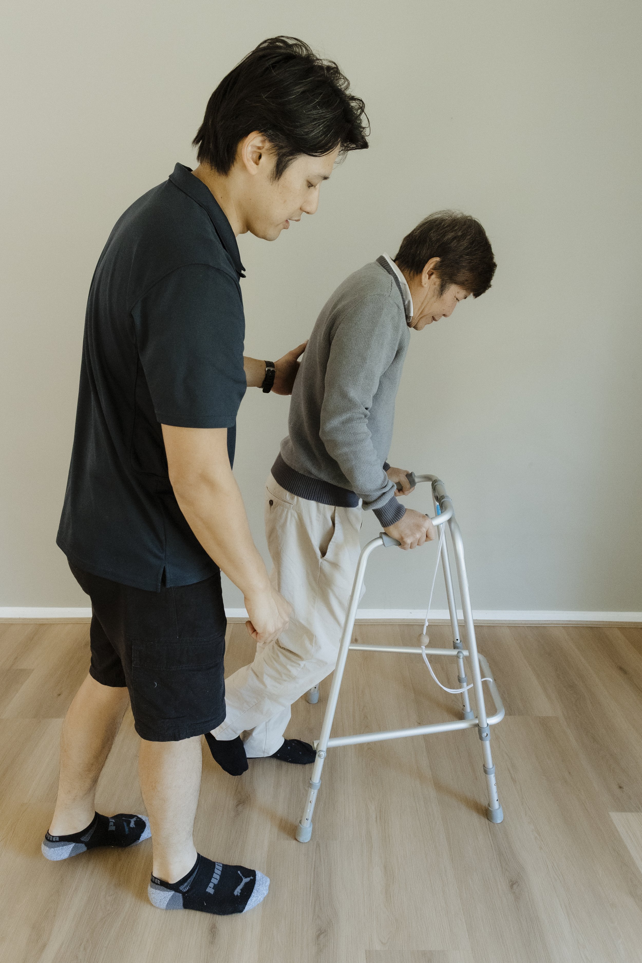 Physiotherapist completing a mobility equipment assessment in a Canberra home.
