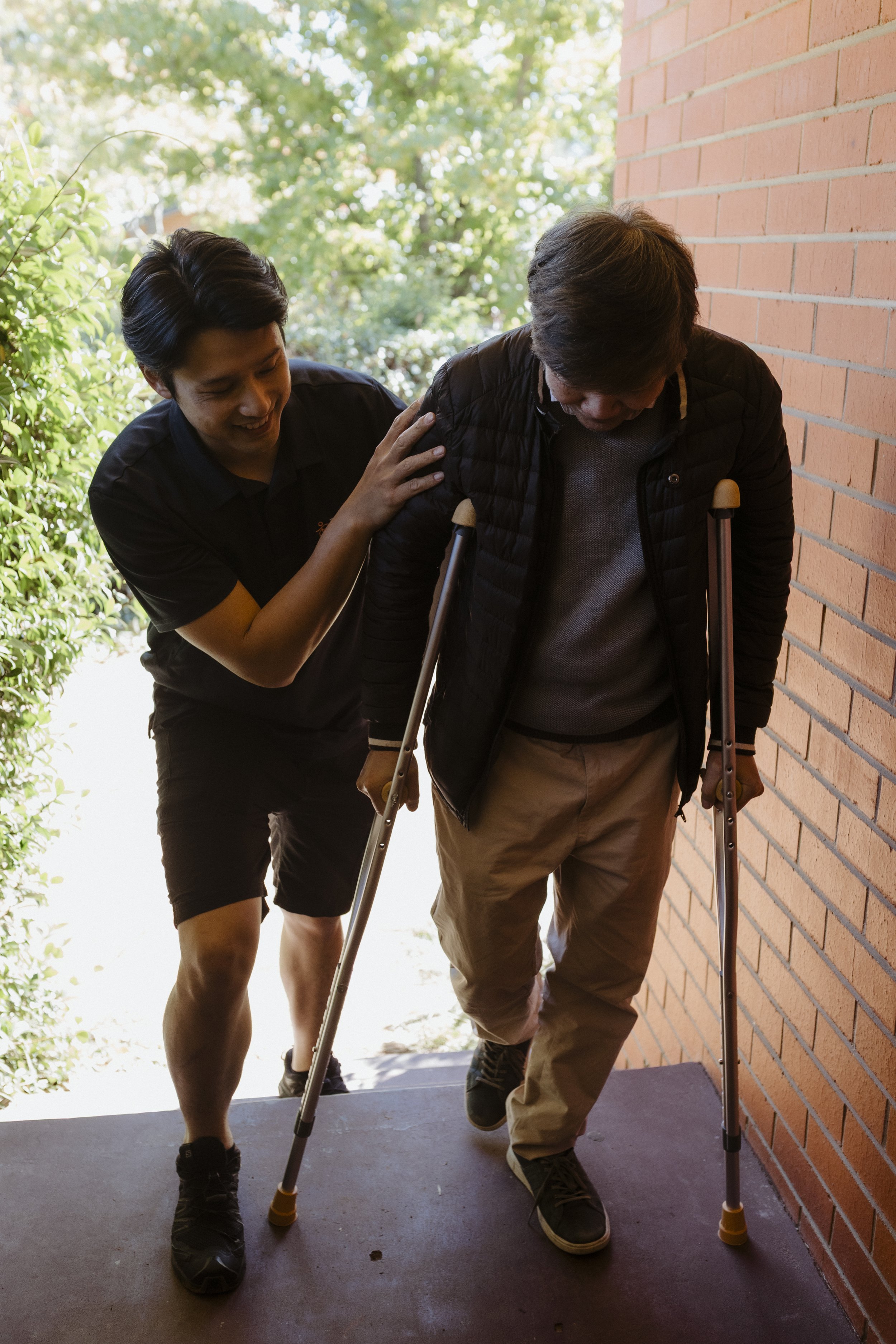 Physiotherapist assessing an NDIS participant for use of crutches