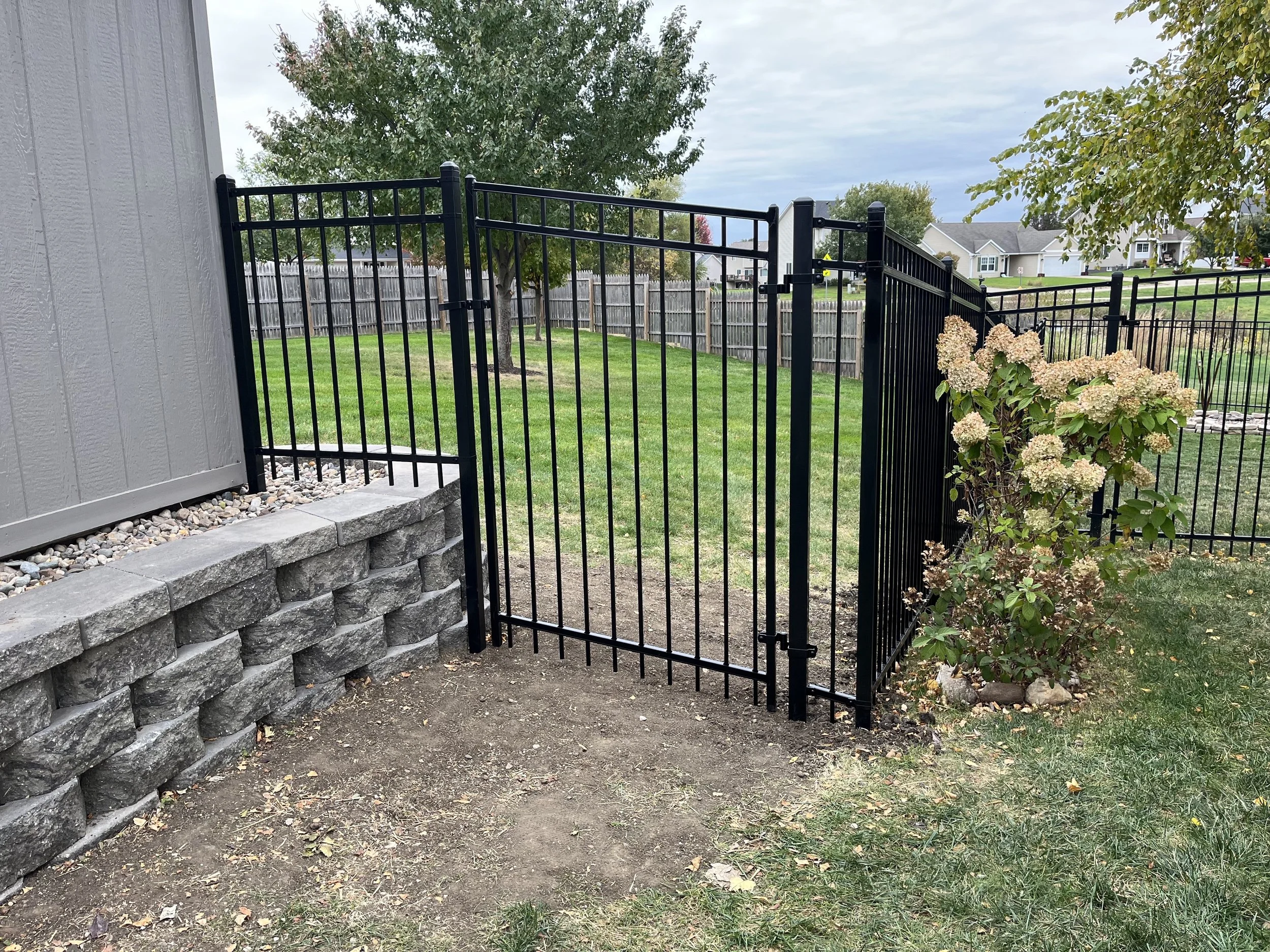6-foot Montage ornamental fence installed in Urbandale, Iowa, including a matching walk gate. This fence provides durable security with a clean, professional appearance.