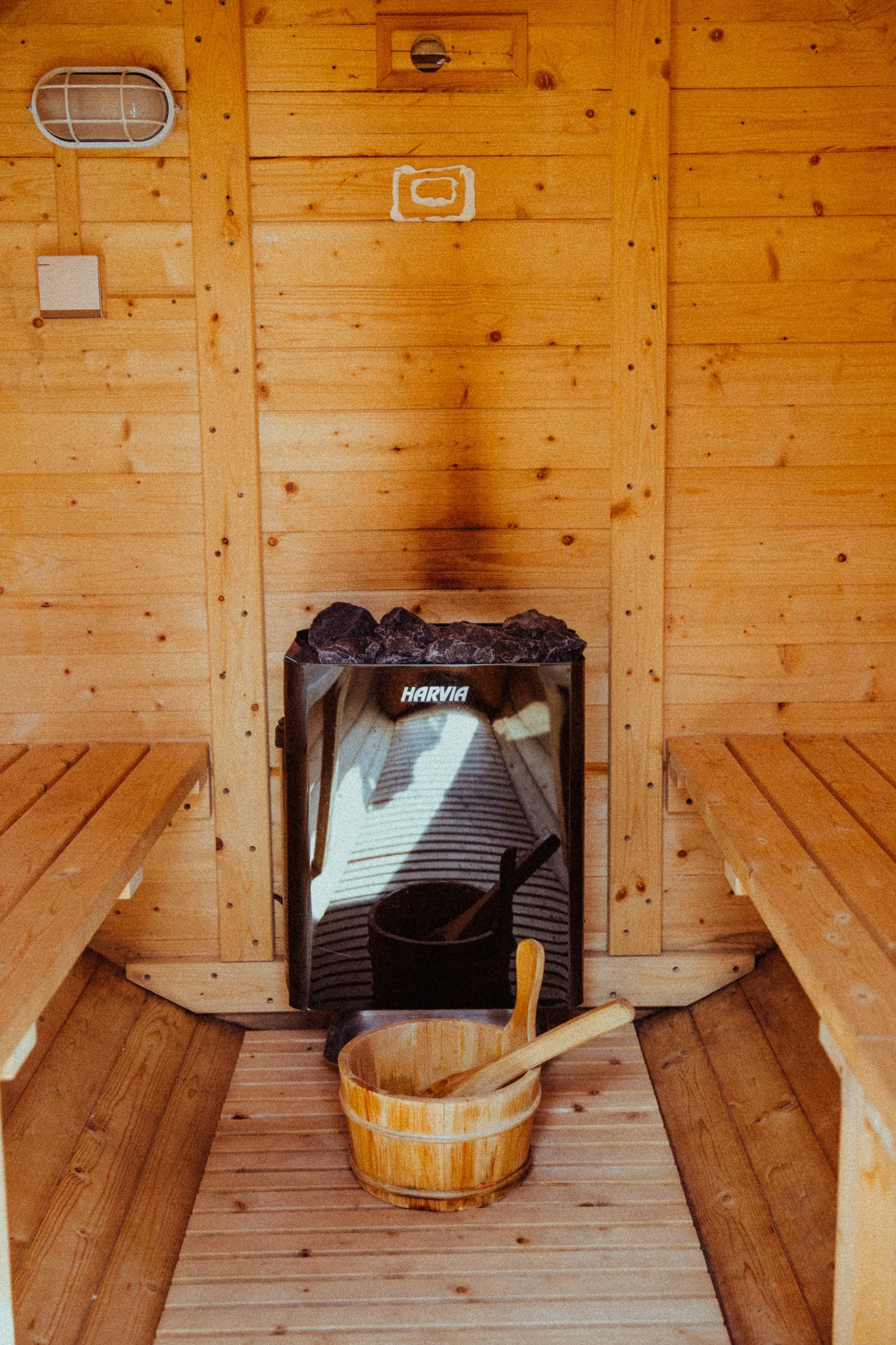 all-wood sauna with wood bucket, symbolizing the warm, grounded full-service partnership that combines content marketing strategy, email newsletters, blog posts, and digital product development for wellness practitioners