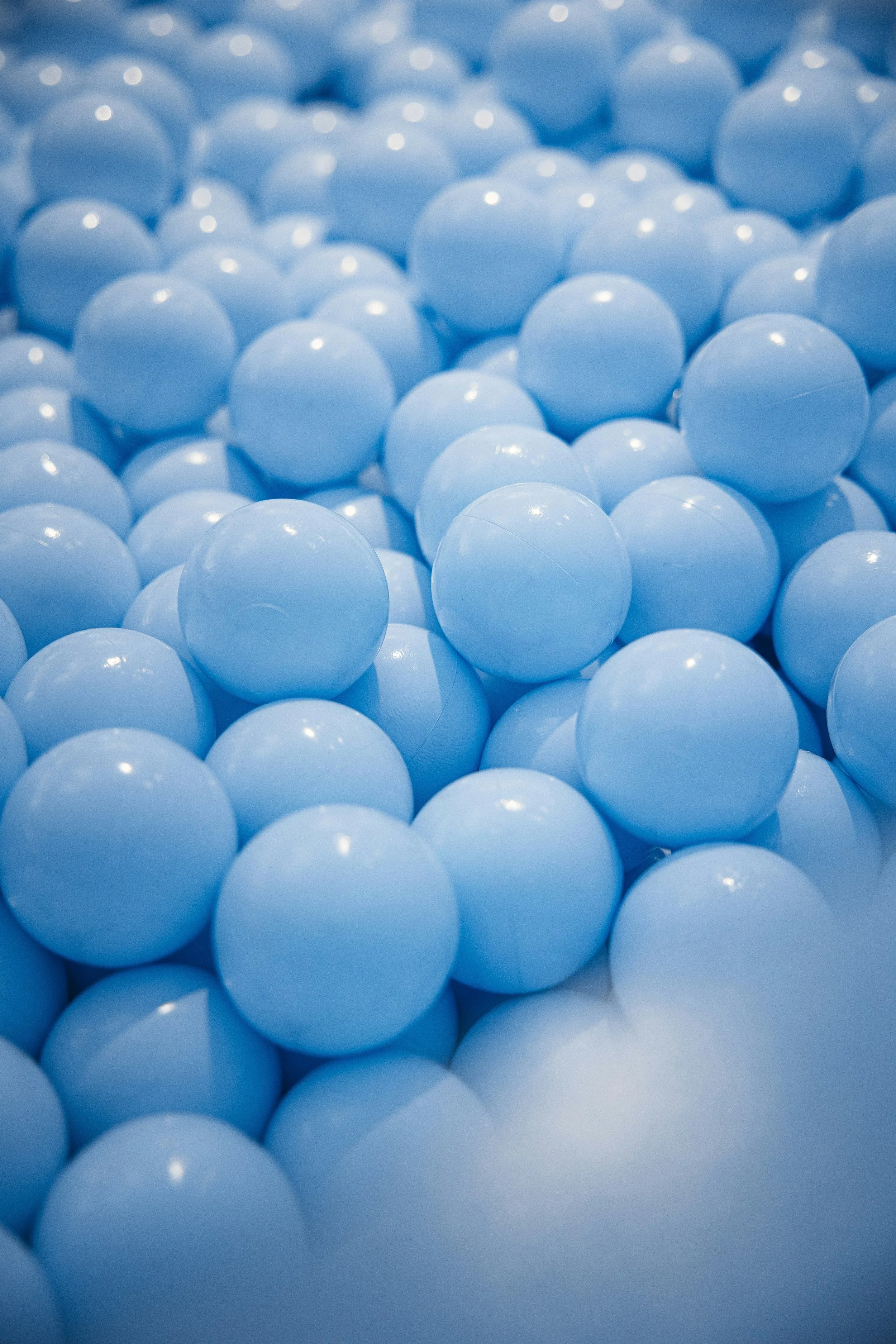 A dense cluster of pale blue balls, echoing the playful, unstuffy side of running this practice