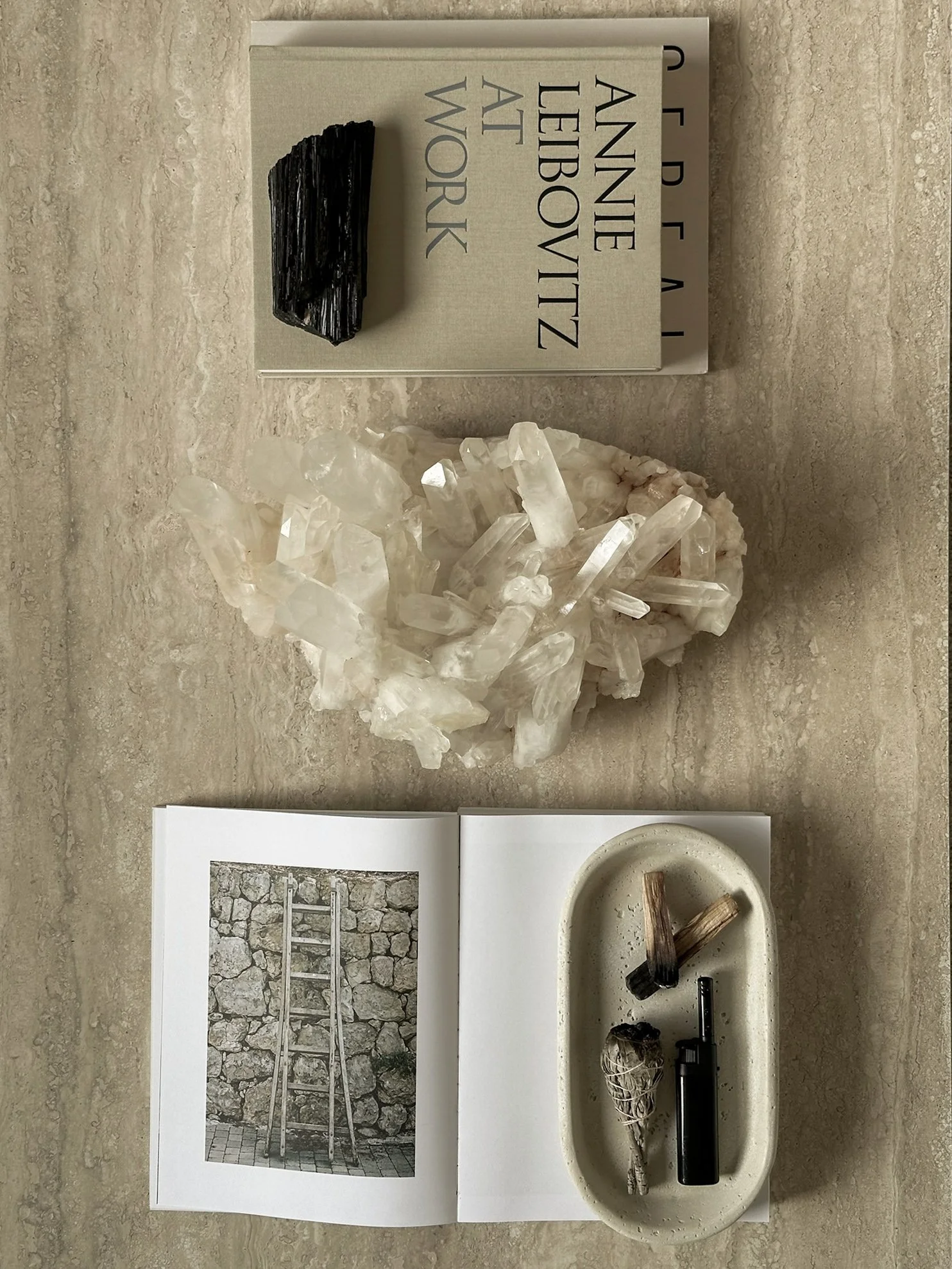 Book, crystals, and burning palo santo arranged on a marble table, conveying the calming aesthetic of healers who use virtual assistant support for digital product launches, content marketing, SEO, and admin tasks.