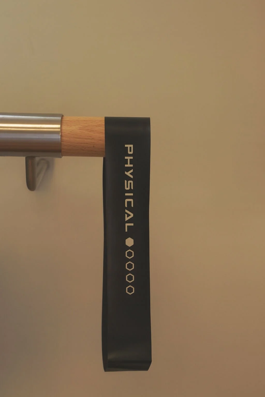 A resistance band hangs from a wooden bar inside the studio of a personal trainer whose virtual assistant handles all of the business's admin and social media.