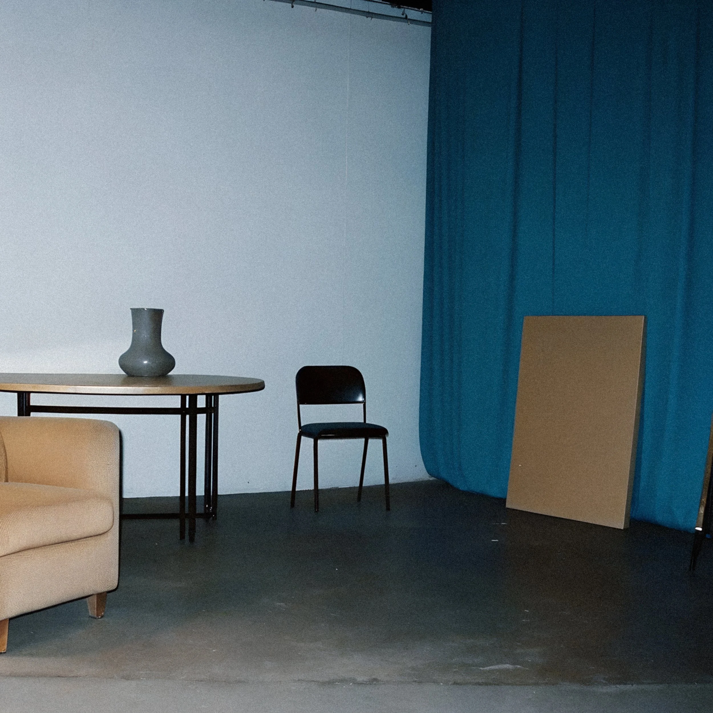 open room with bright blue curtain divider, tan armchair, and folding chair, reflecting the welcoming, collaborative nature of working with a specialized VA for content marketing and website copywriting