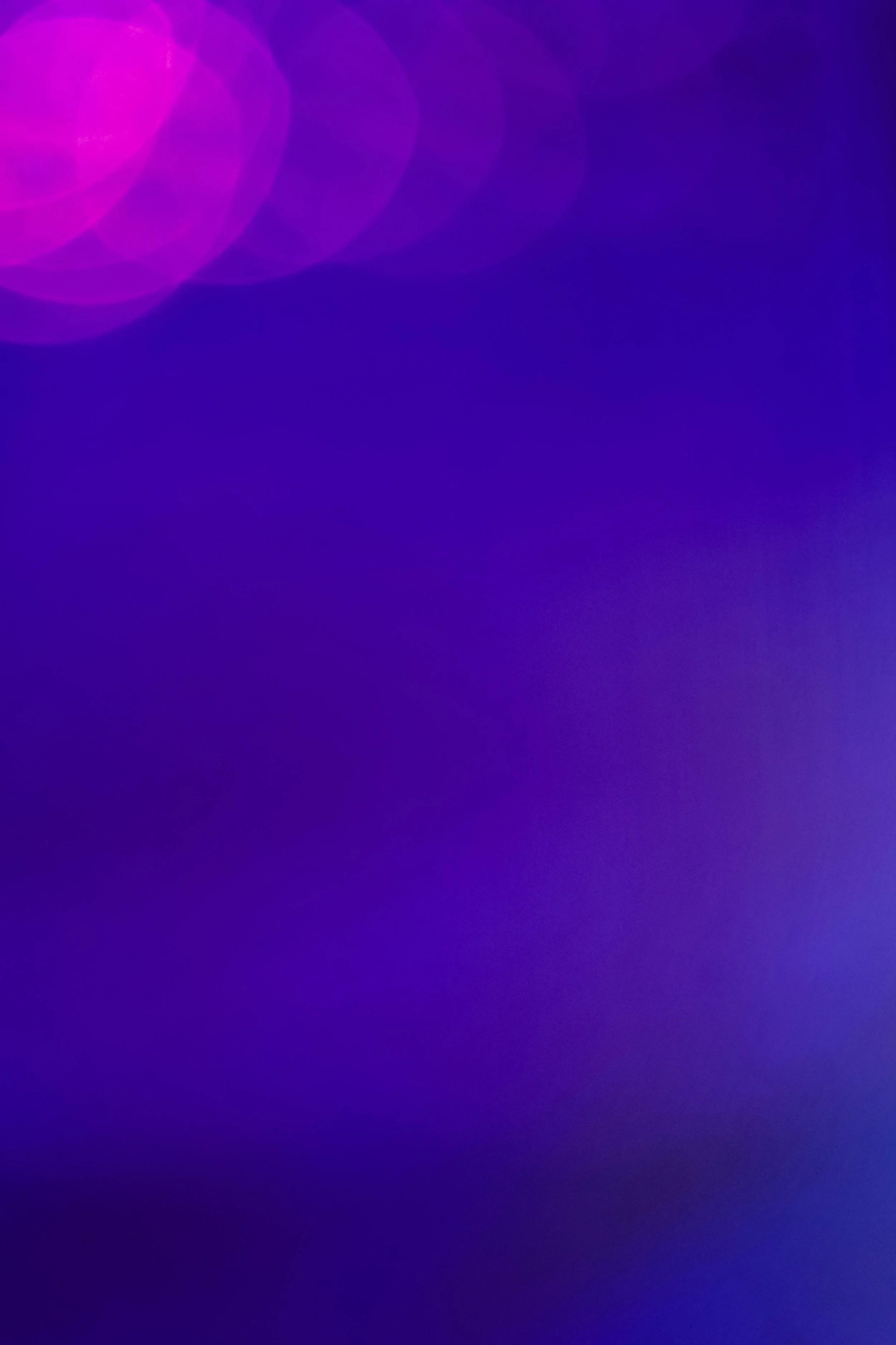 A soft, blurred glow of purple and blue light, evoking the quiet, steady presence of content working in the background