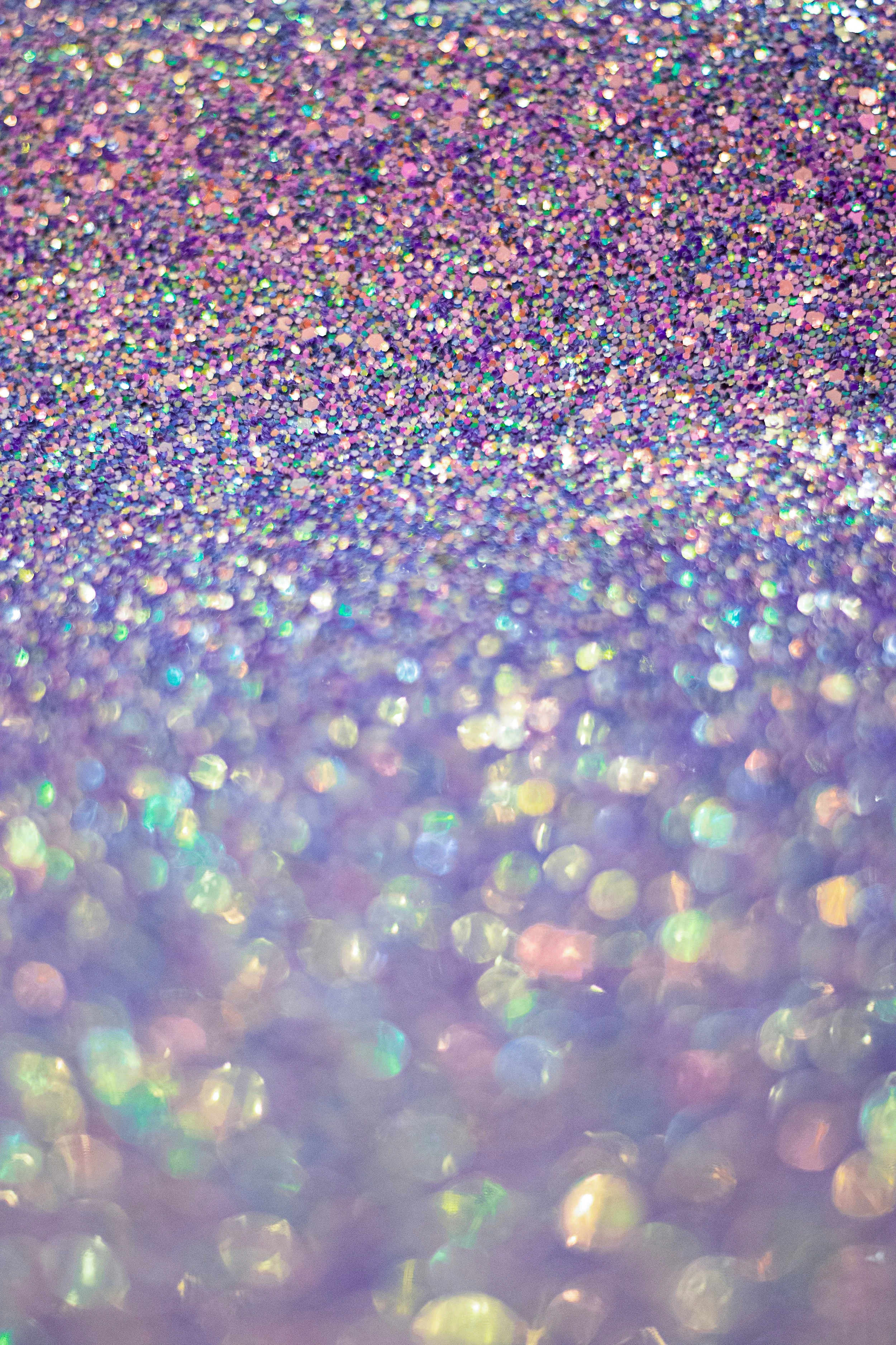 Multicolor glitter fading from dense sparkle to soft blur, evoking the build-up of excitement before launch day