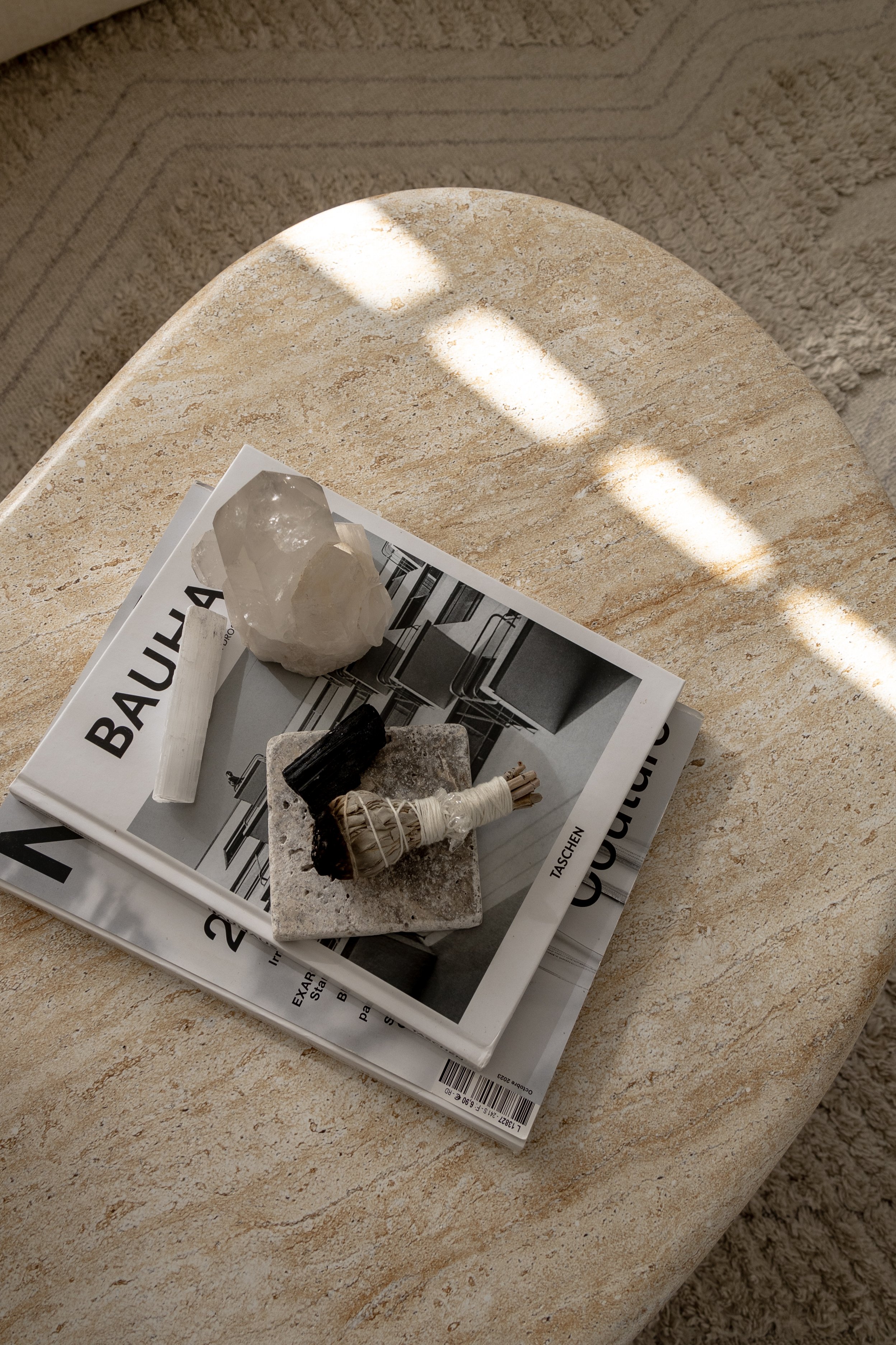 Marble coffee table with stacked books topped by a sage bundle and crystals, capturing a healer-aligned wellness aesthetic supported by virtual assistant services for launches, marketing, SEO, and admin.