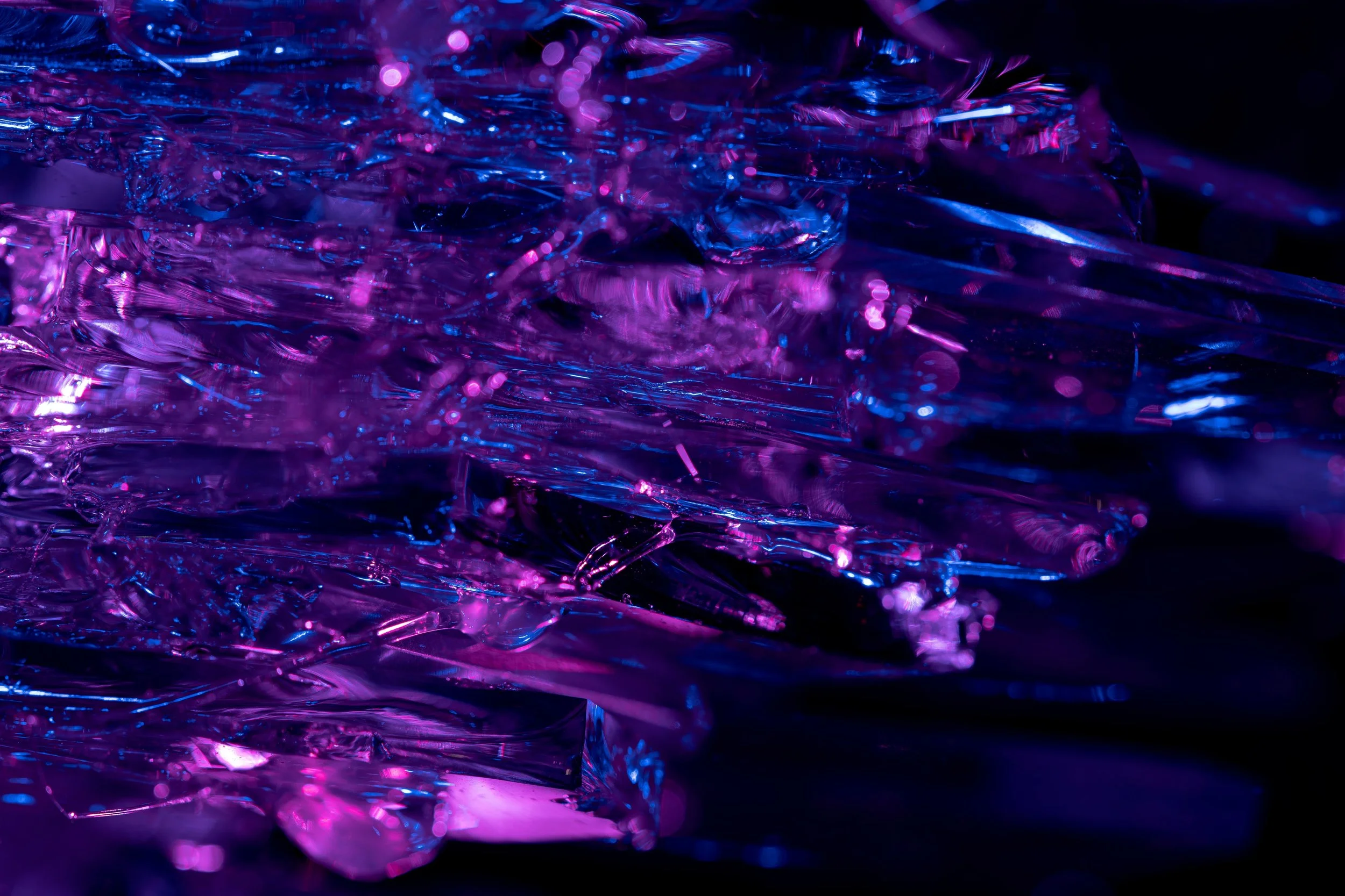 Crinkled purple and pink foil catching dramatic light, capturing the high-energy moment a cart opens