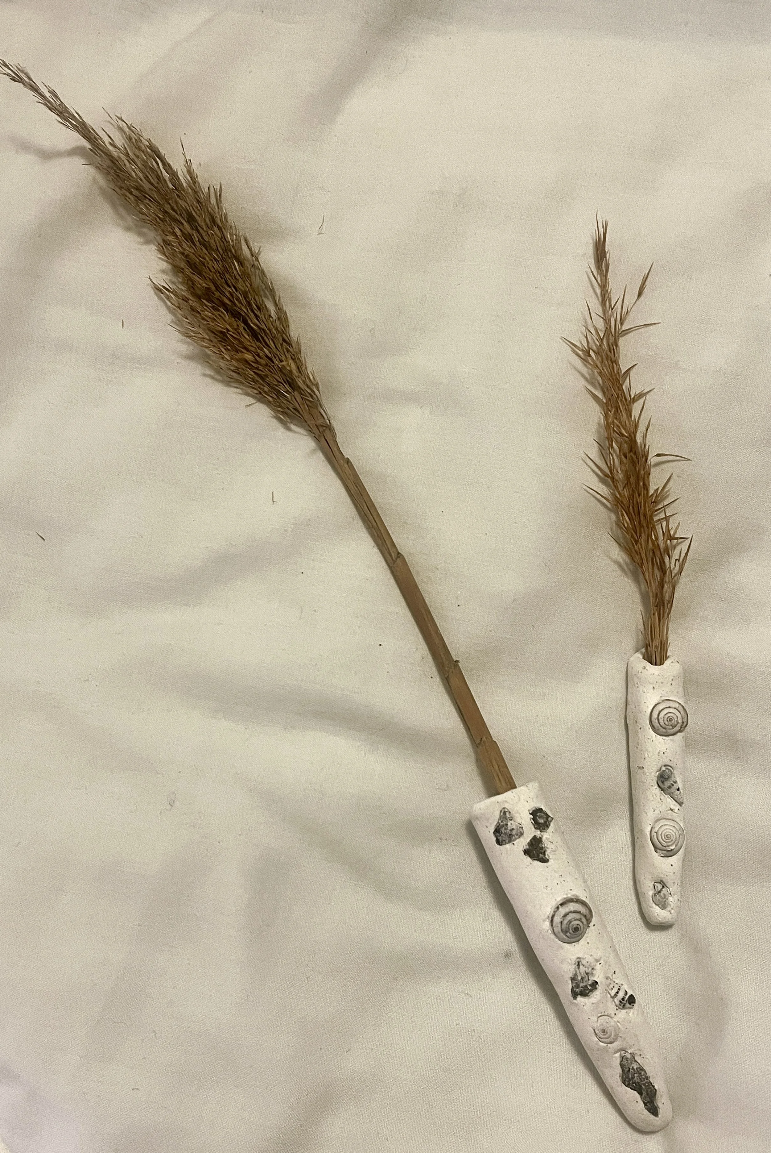 One-of-a-kind magnetic vases made with island sand, shells, plants and other found items