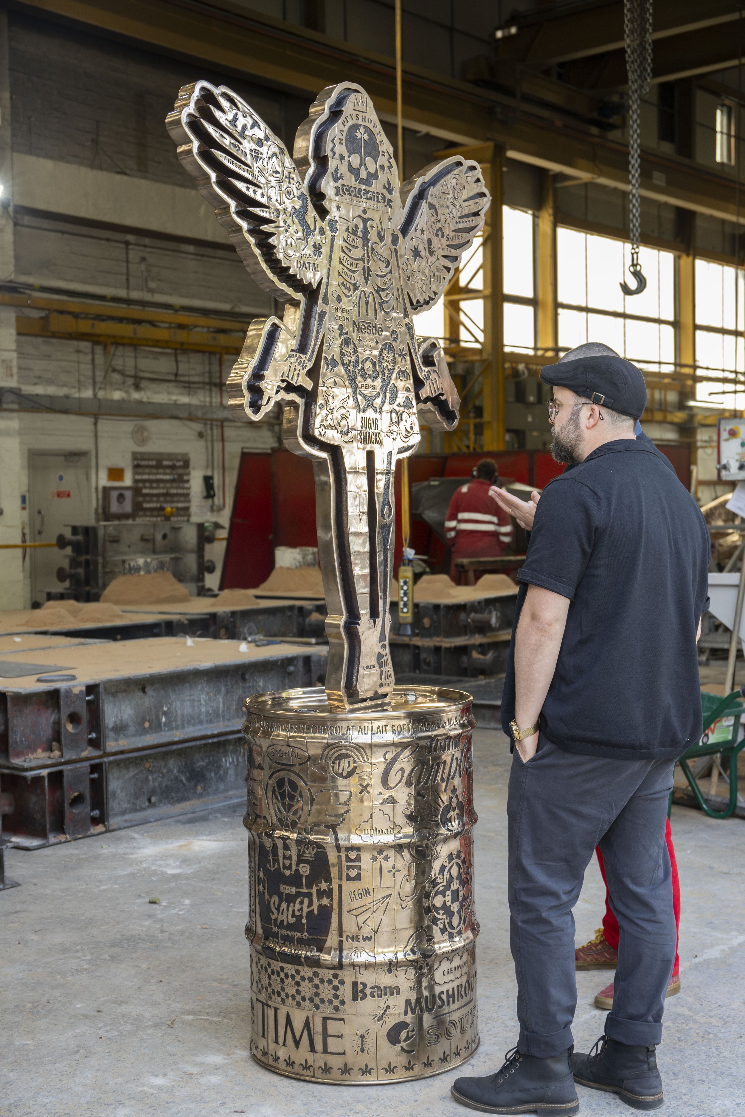Close-up of Lhouette's A Fall from Grace – Angel Cake bronze sculpture at Pangolin Editions foundry, showing details of the contemporary sculptural artwork.