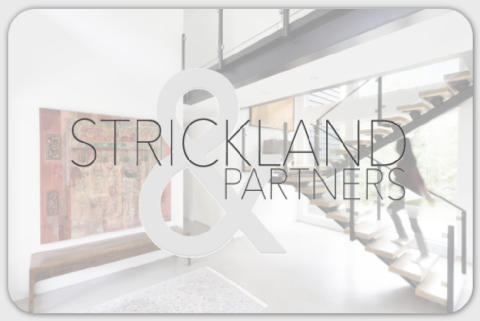 Interior of a modern building with a staircase, large window, art on the wall, and the text 'Strickland & Partners' overlaid.