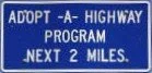Tompkins county adopt a highway program sign.