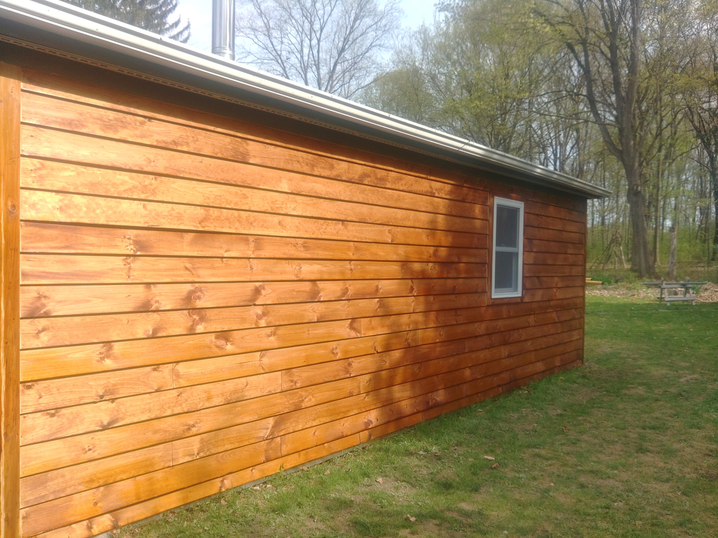 Building with white pine clapboard siding, finished with pine tar and linseed oil stain.