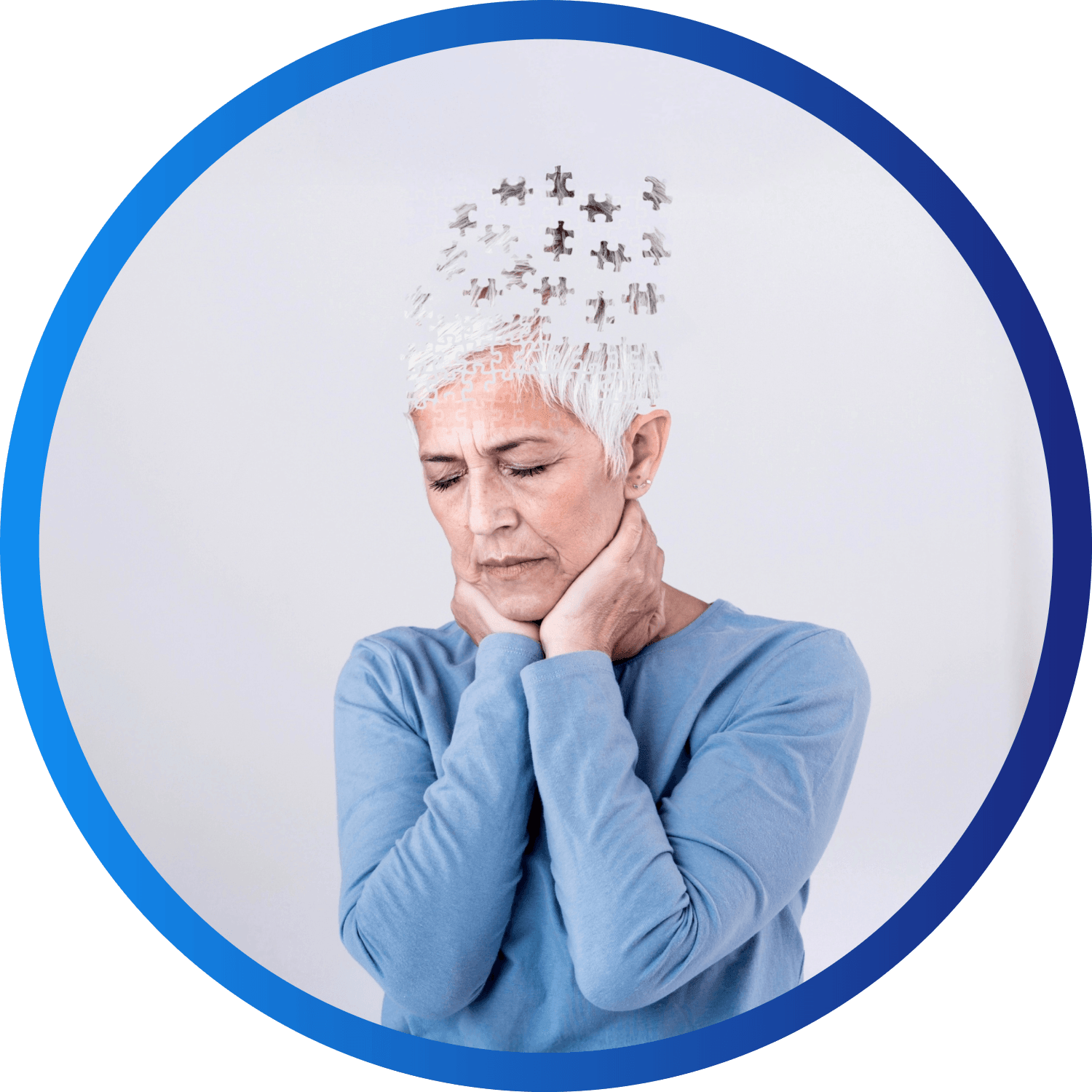 Close-up of a hand holding a small orange, rubbery, human ear model against a white background.