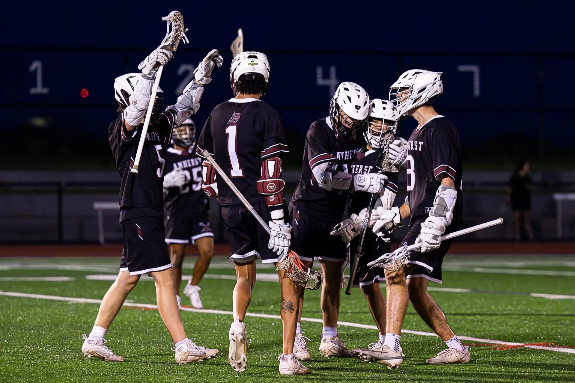 Amherst lacrosse players celebrate a late goal during a 9-6 victory over Northampton in the Western Mass Championship at West Springfield High School on May 27, 2025