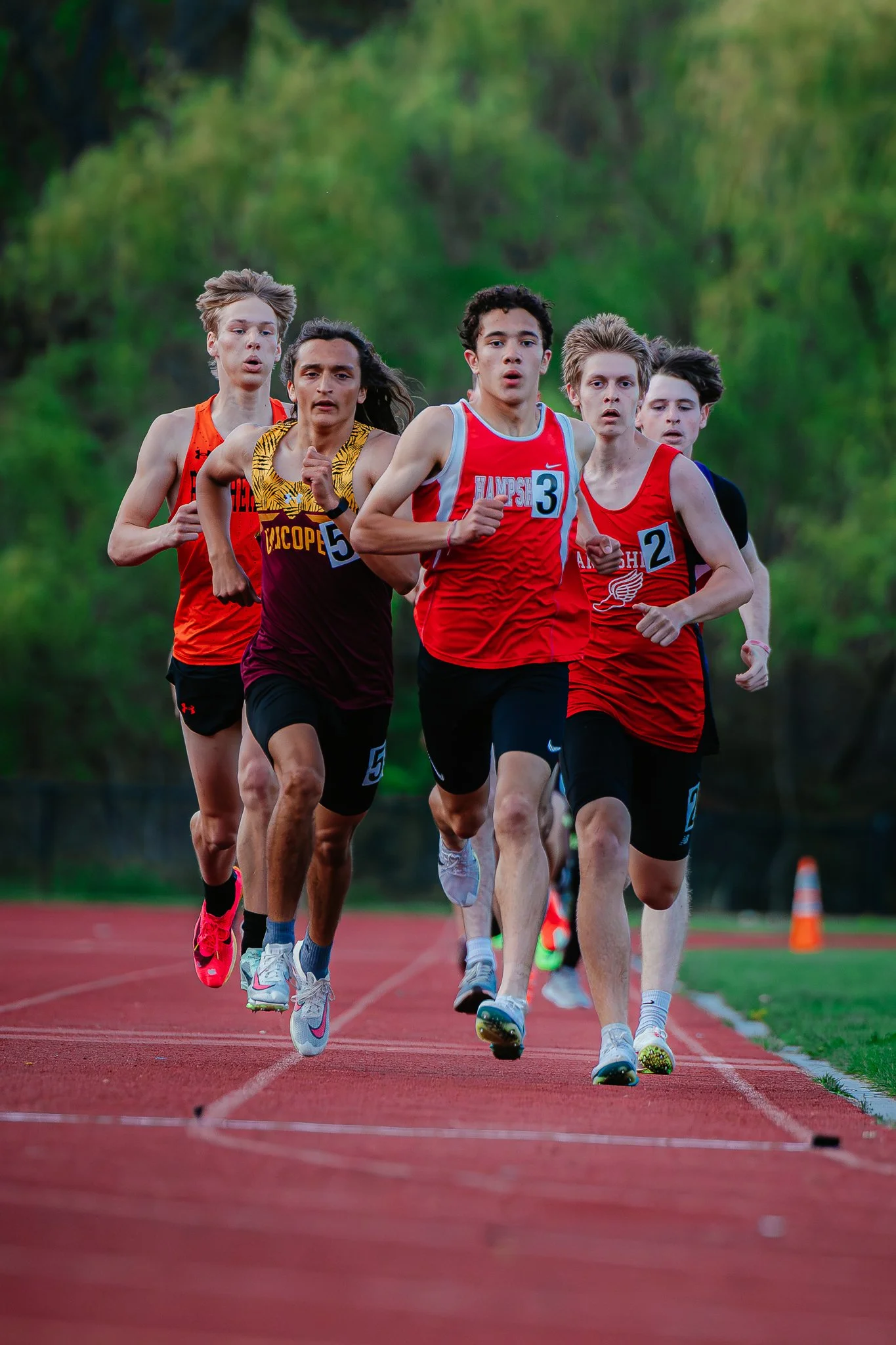 Boston Globe | Runners from several schools come down the straightaway during the running of the 800 at the Spartan Invitational on May 2, 2025, at Hampshire Regional High.