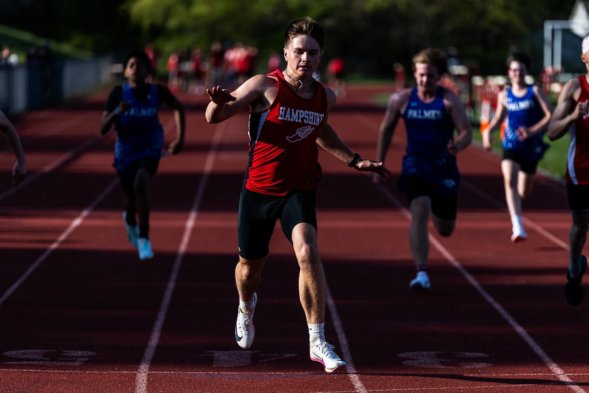 Hampshire freshman Jackson Galenski crosses the finish line during the 1st heat of the 100m race during the meet against Palmer at Hampshire Regional High School on May 4, 2026. 