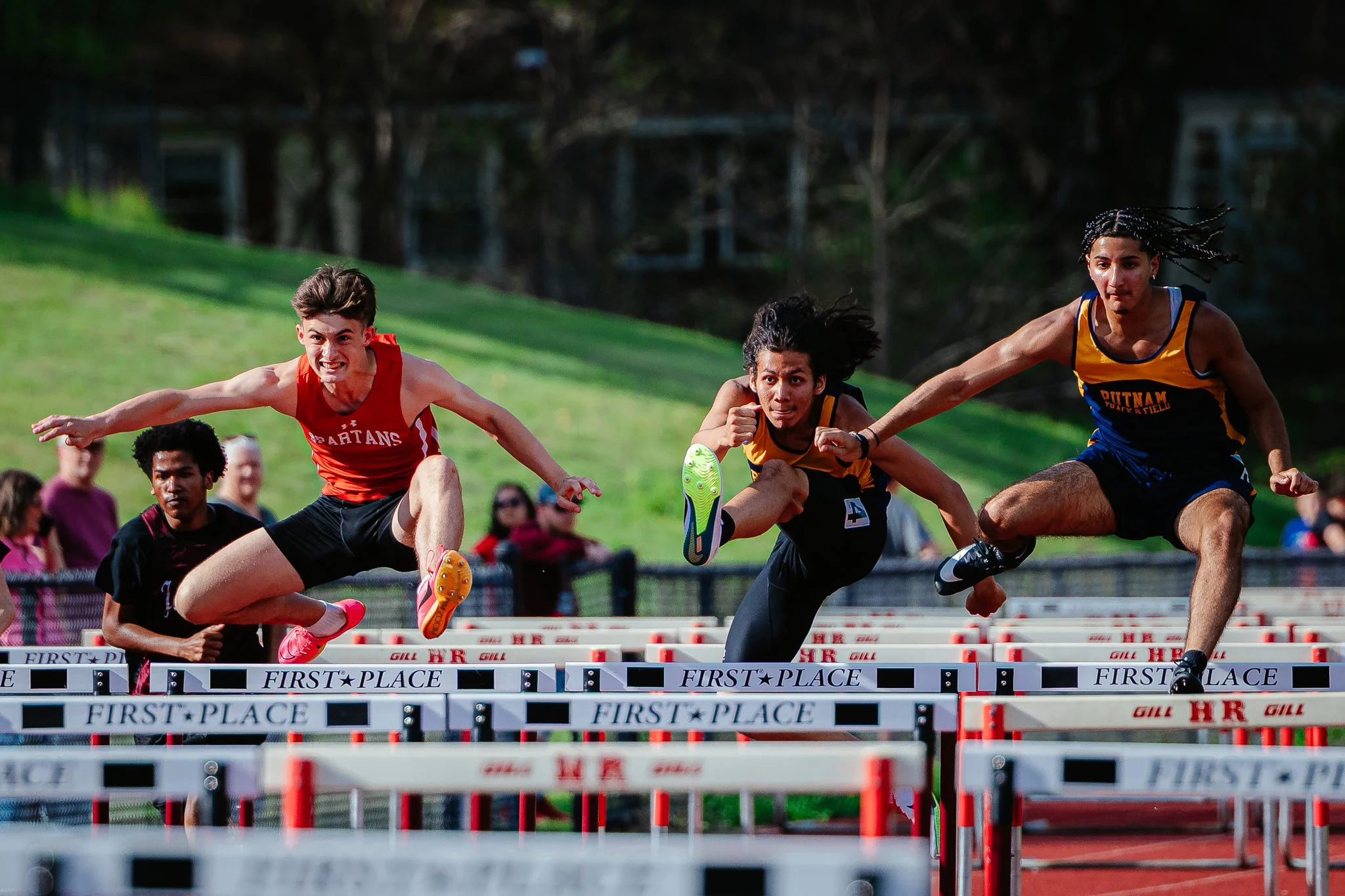 Boston Globe | Runners take flight during the 110-meter hurdles during the Spartan Invitational at Hampshire Regional on May 2, 2025. 