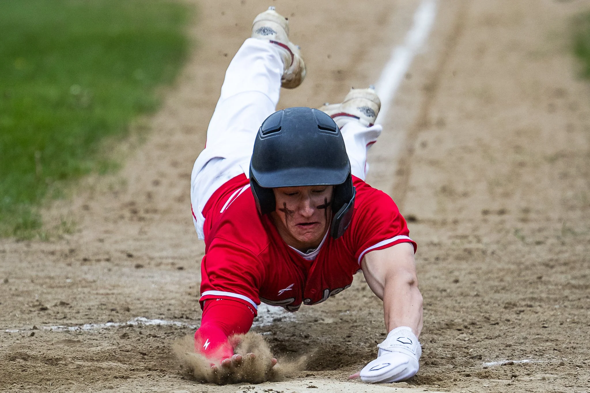 Hampshire Senior Jacob Sicard slides into home plate during a 4-3 win over Southwick at Hampshire Regional High School on May 14, 2025. 