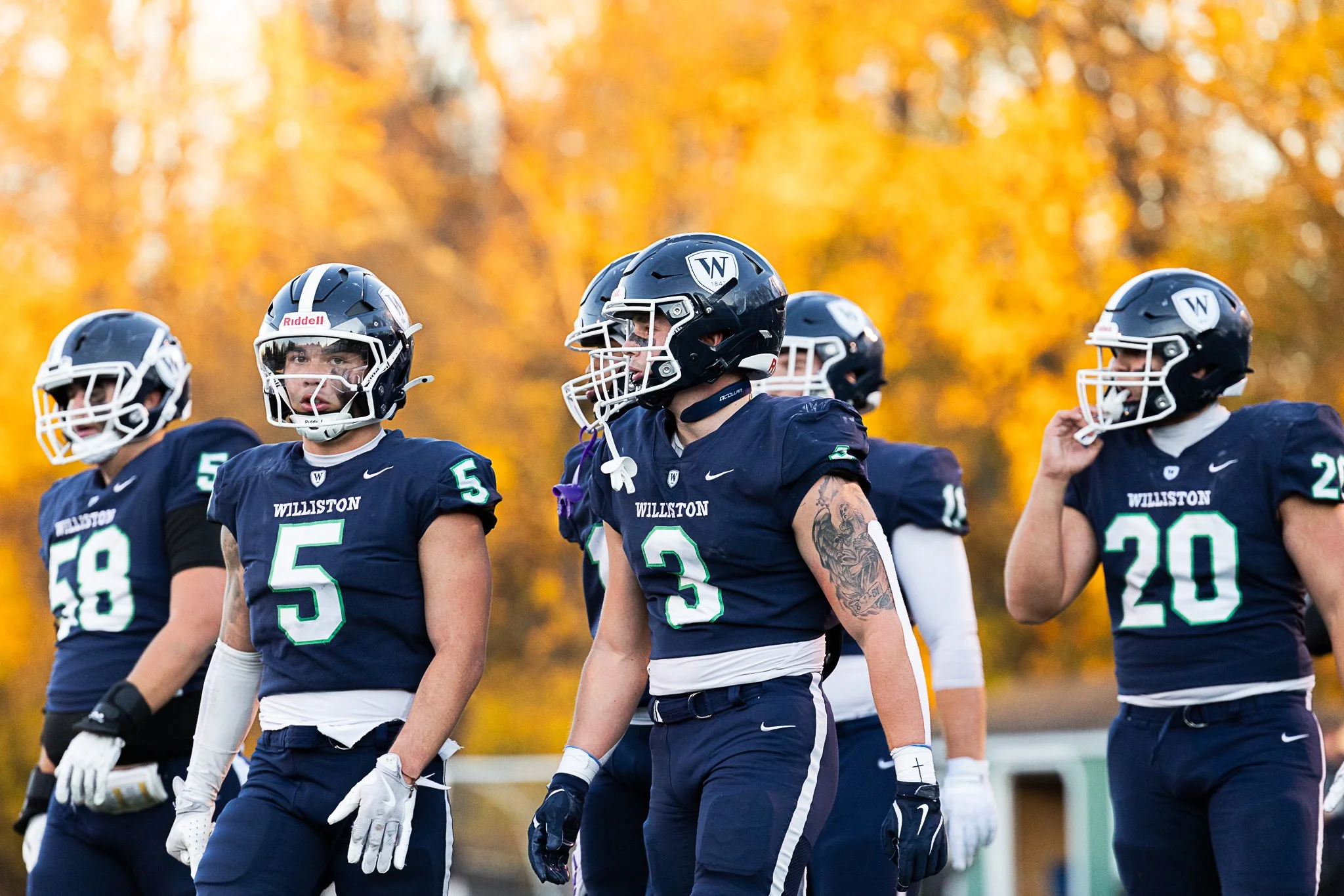 Golden light hits the trees during sunset during a football game between Williston and Brunswick at Sawyer Field on November 8, 2025.
