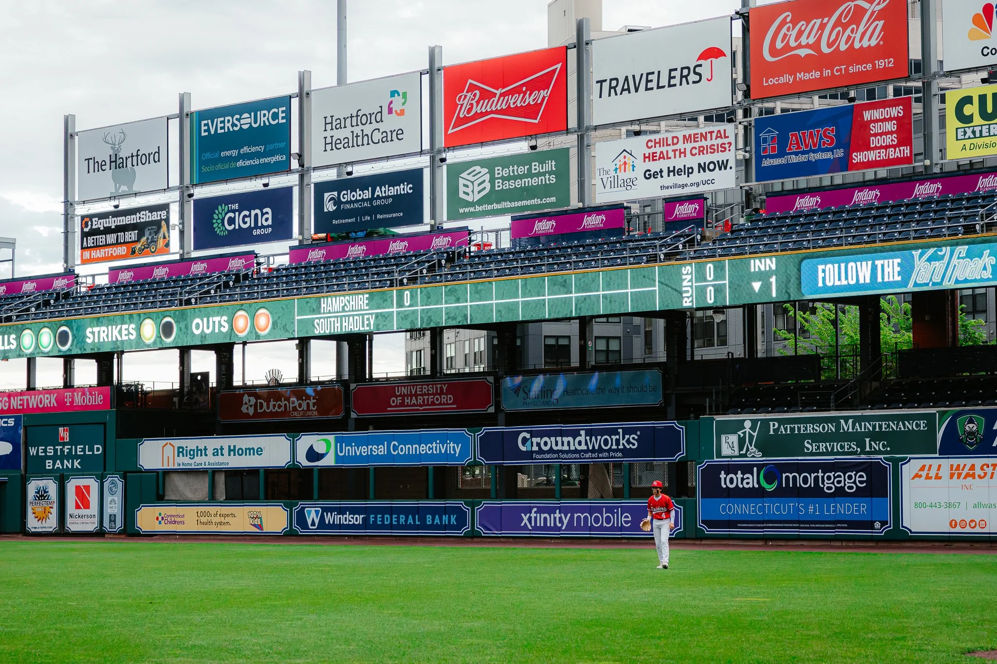 Boston Globe | Hampshire outfielder Jonny Angers wait for a ball to be hit his way during a game with South Hadley held at Dunkin' Park in Hartford, Conn., on May 8, 2025.
