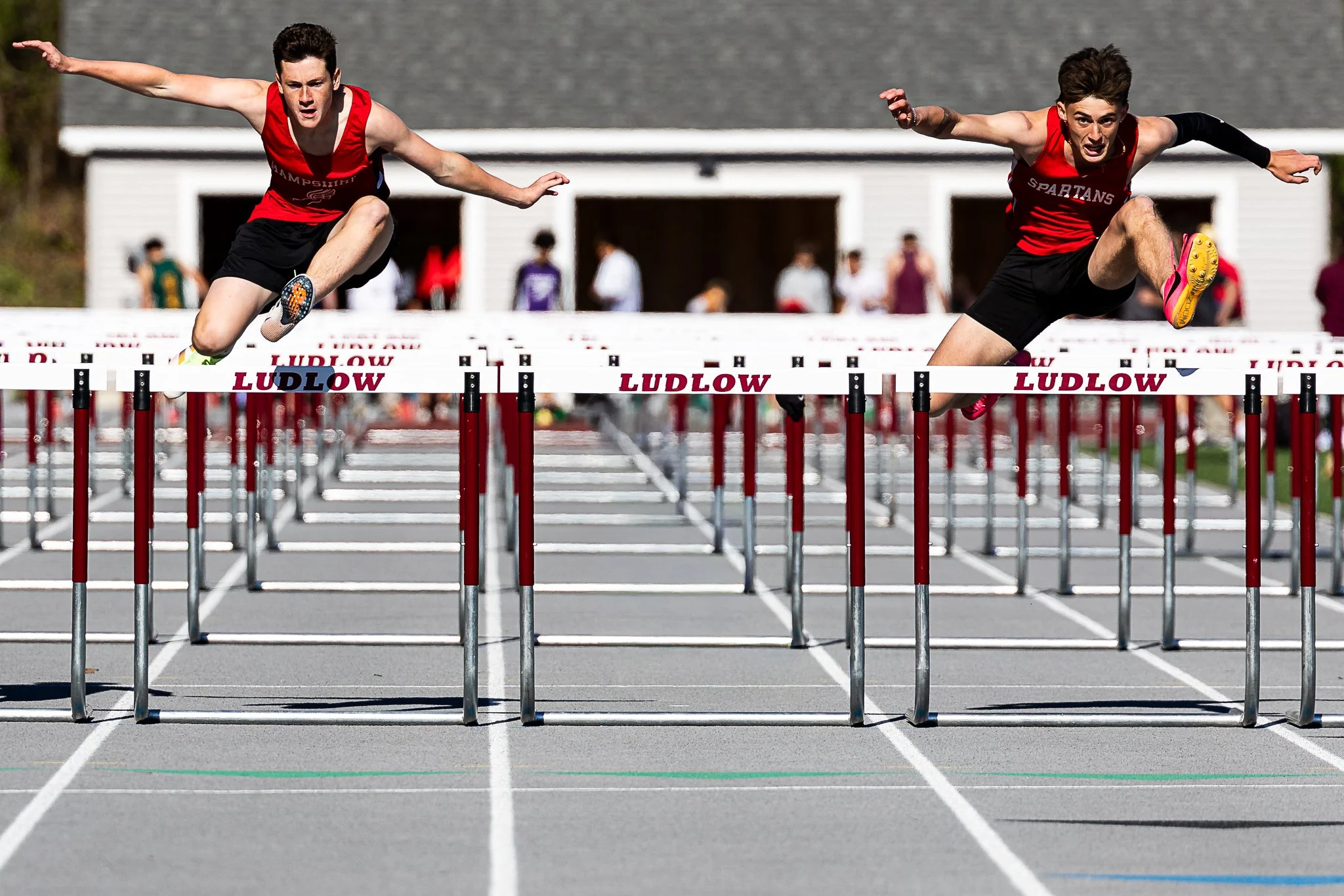 Hampshire junior Isaac Stith (left), competes in the 110m hurdles during the Lion Invitational at Ludlow High School on May 8, 2025. 