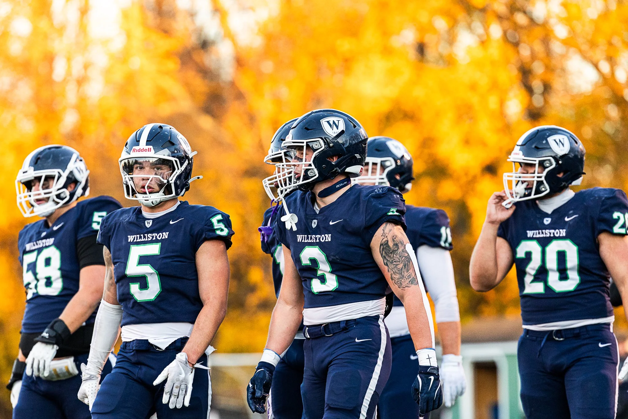 Williston players return to the field surrounded by golden sunlight during a game against Brunswick at Sawyer Field on November 8, 2025. 
