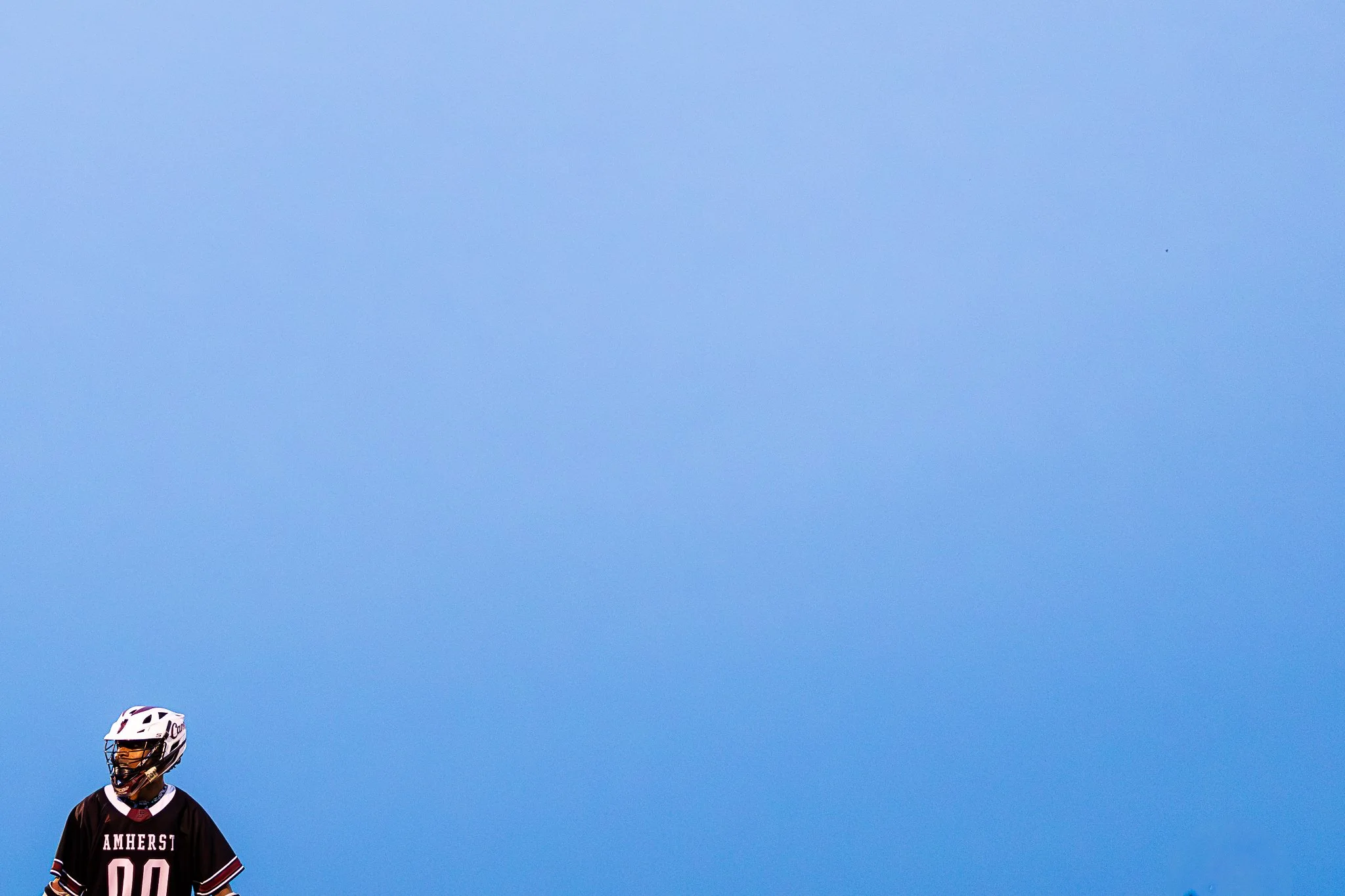 Amherst lacrosse player beneath the blue sky during the Class B Western Mass Championship against Northampton High School at West Springfield High School on May 27, 2025. 