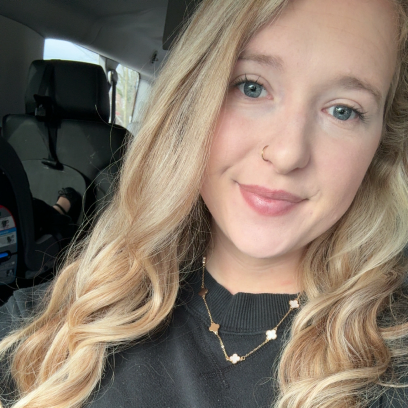 Photo of Katlyn Castillo wearing a black sweatshirt and gold necklace