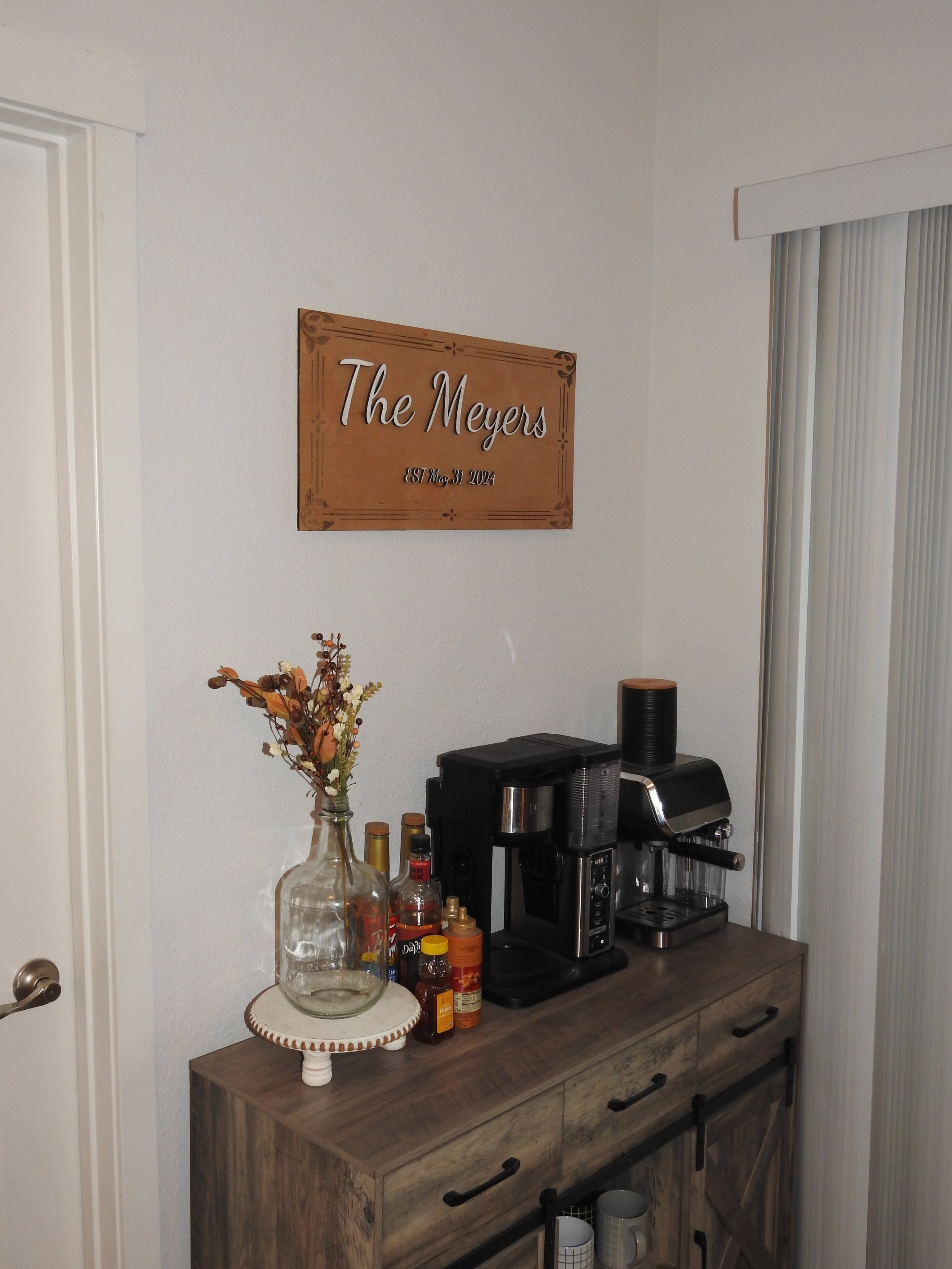 Rustic kitchen nook with coffee station, wall sign, and decor