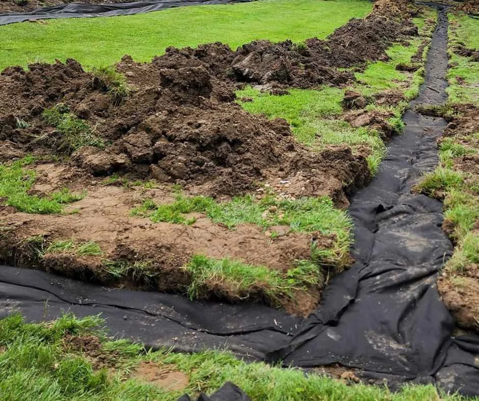 french drain being covered.jpg