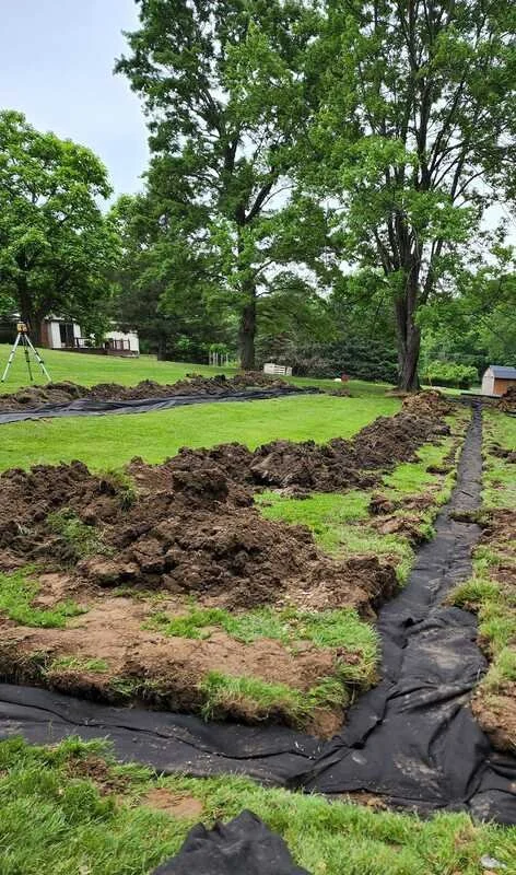 french drain wrapped up and nearly complete.jpg