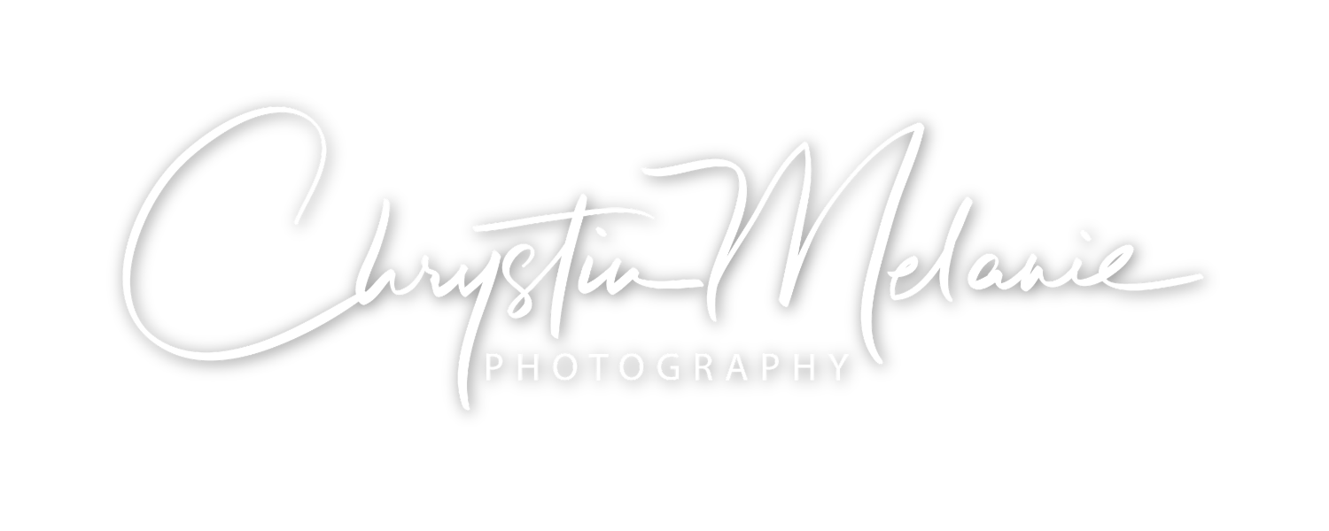 Logo for Chrystin Melanie Photography with black background and white handwritten style text.