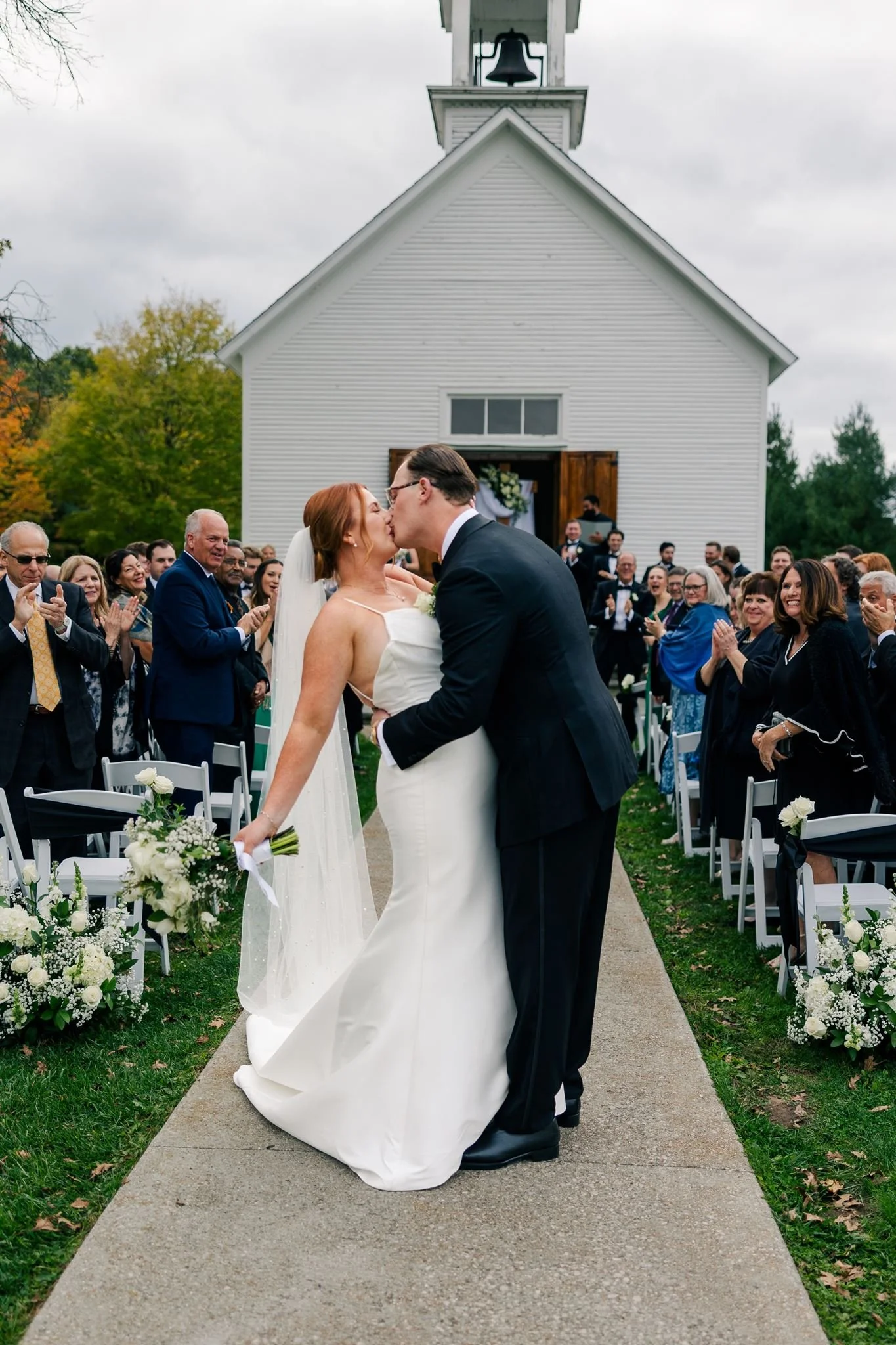 bride-groom-kiss-in-front-of-chapel-at-felt-estate.jpg
