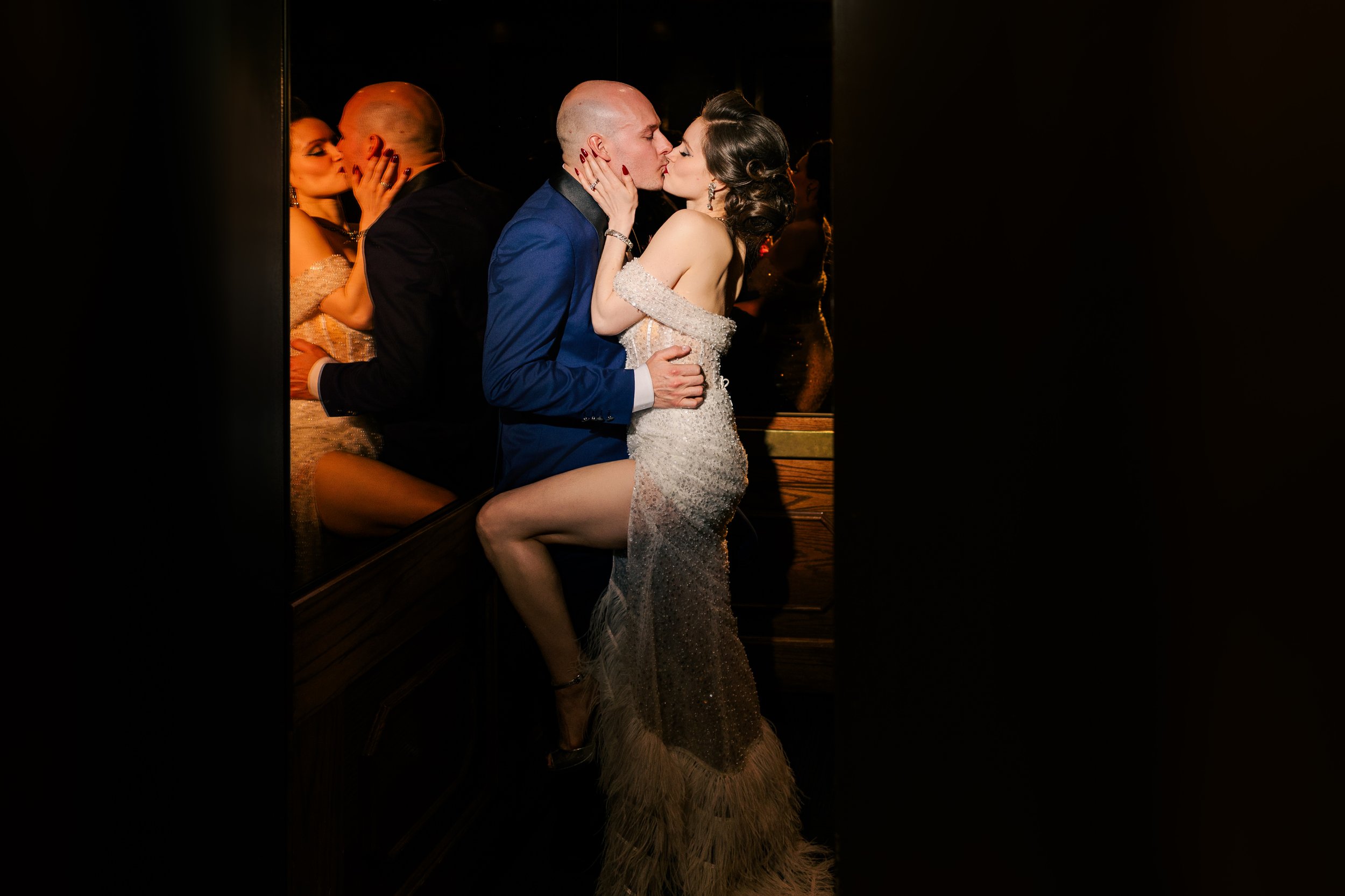 Bride and Groom kissing in elevator, dark and moody, at City Flatt's Hotel in Grand Rapids Michigan