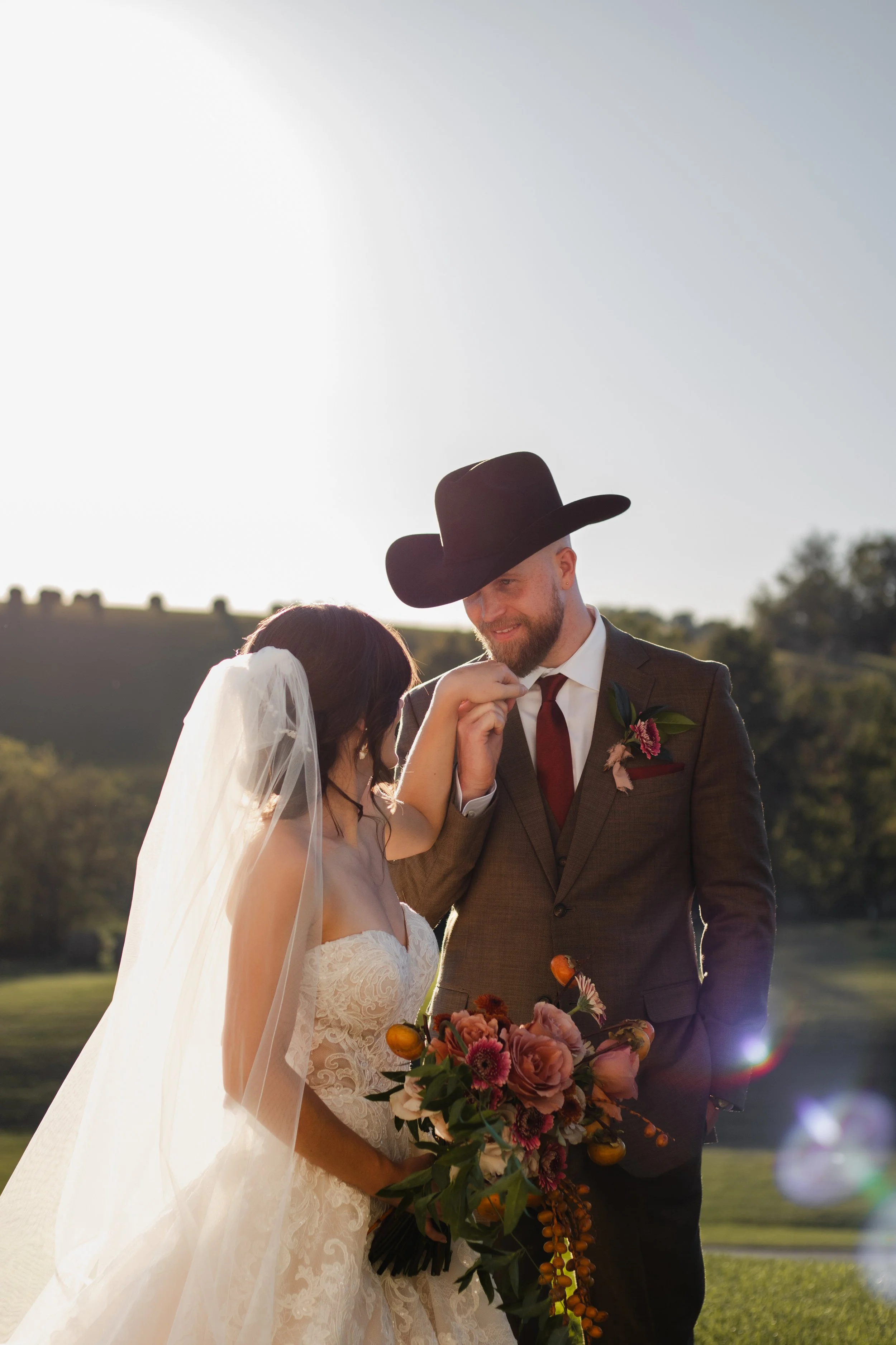 Golden hour portraits of western style wedding couple outside