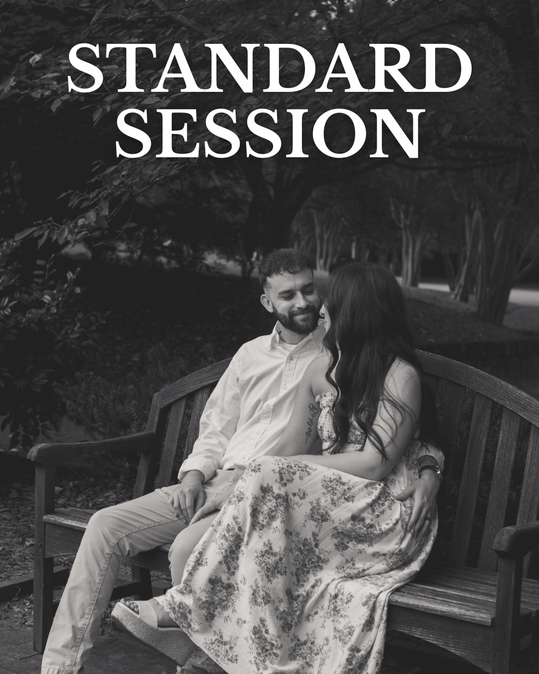 A black-and-white photo of a man and woman sitting close on a wooden park bench, smiling at each other, with trees in the background. The words "Standard Session" are written in large white letters at the top.