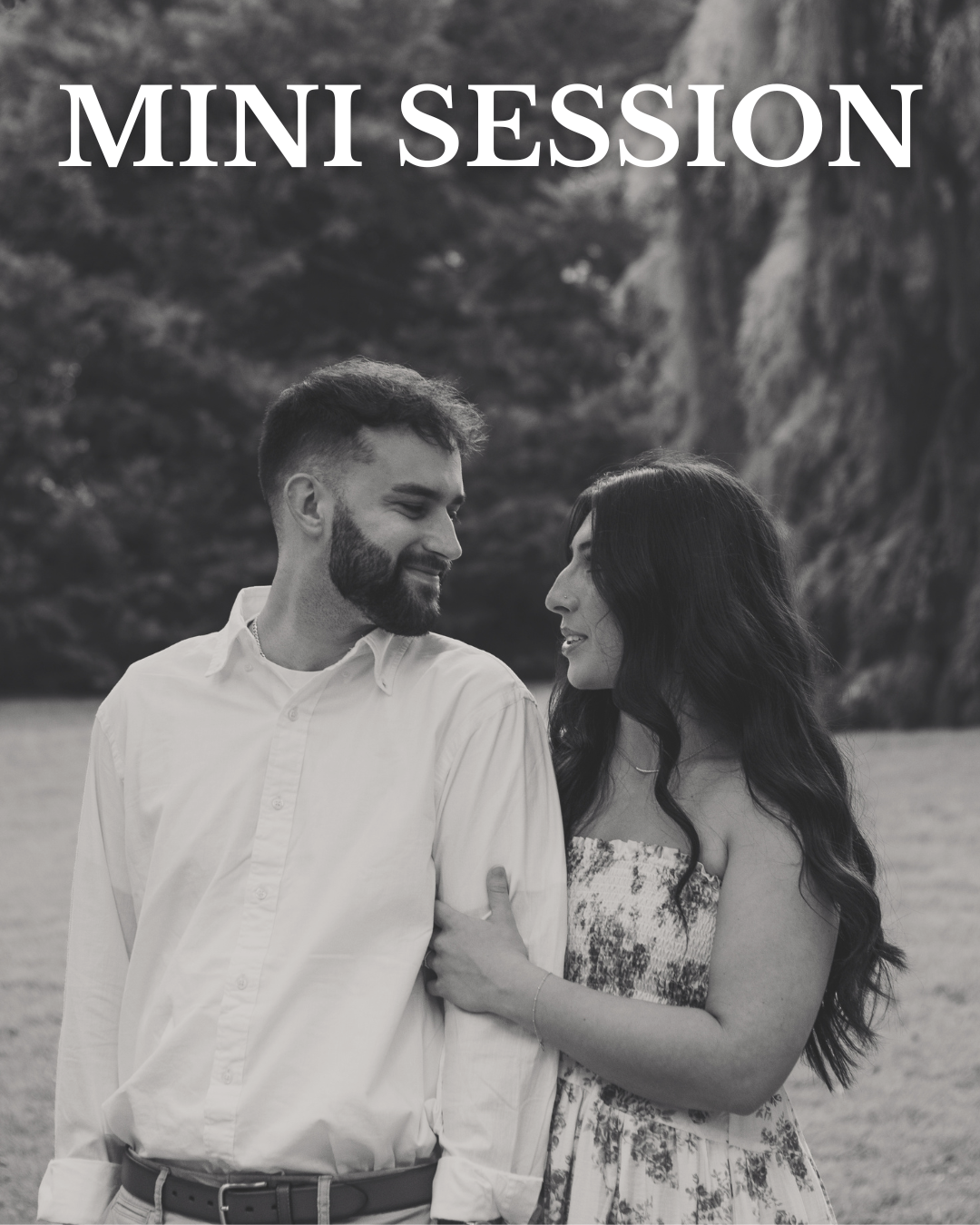 A black and white photo of a man and woman standing close together outdoors, smiling at each other, with mountains in the background. The text 'Mini Session' is written at the top.