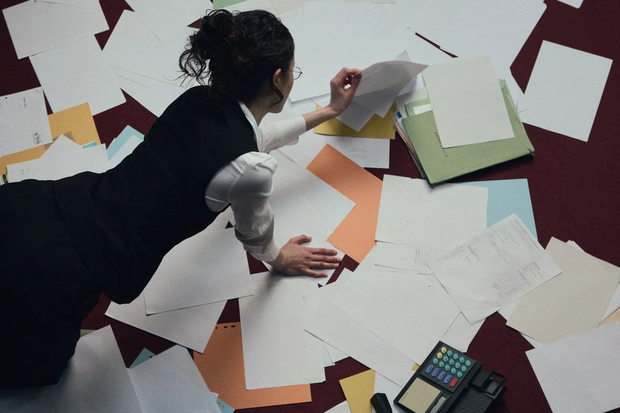 woman surrounded by paperwork