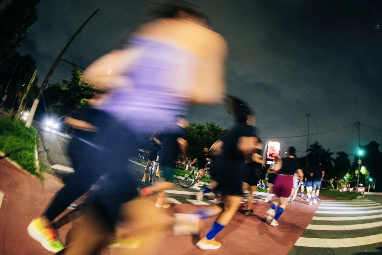 Runners running in a city at night