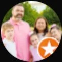 Family posing outdoors, smiling, with a star icon in the corner.