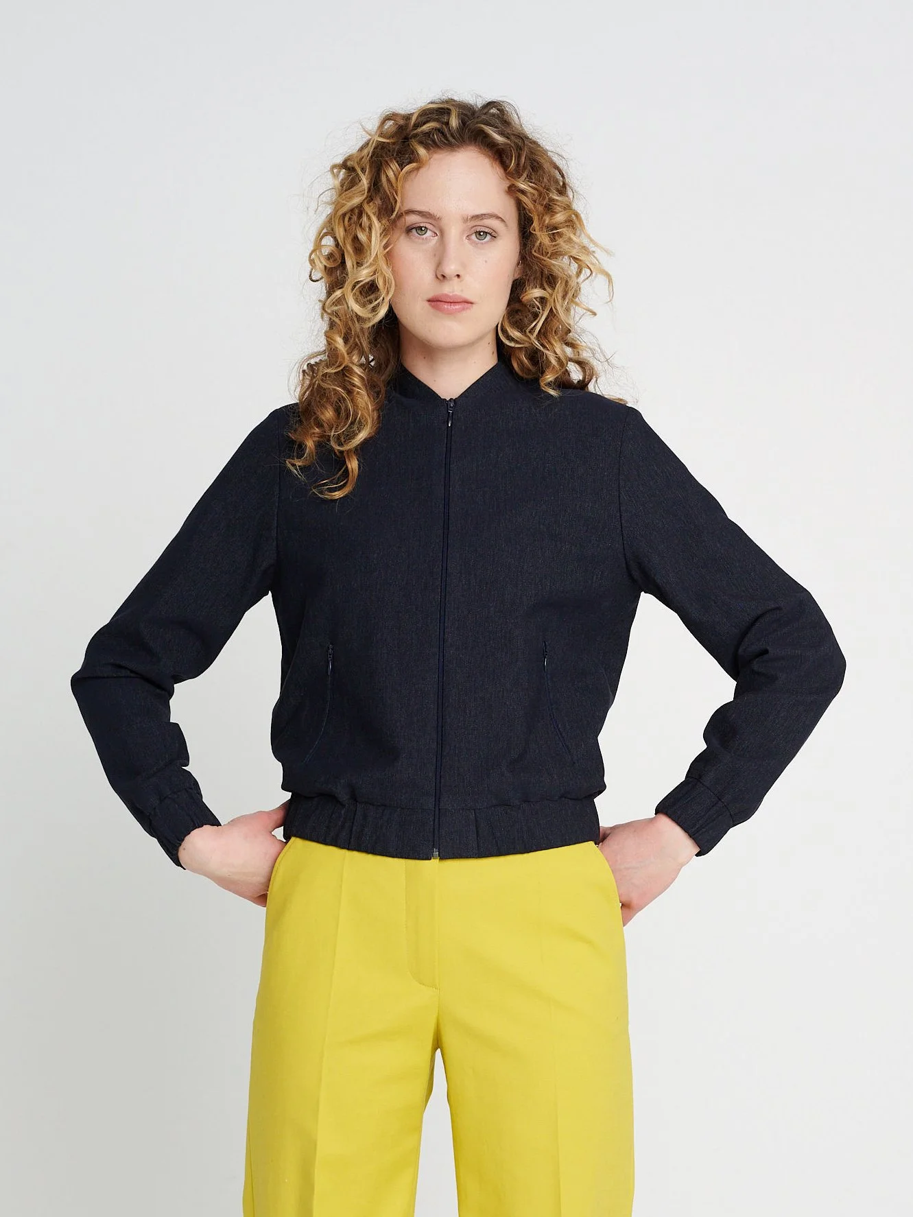 Bomberjacke aus Jeans mit Reißverschlusstaschen und Stehkragen, Hüftlang, locker geschnitten.