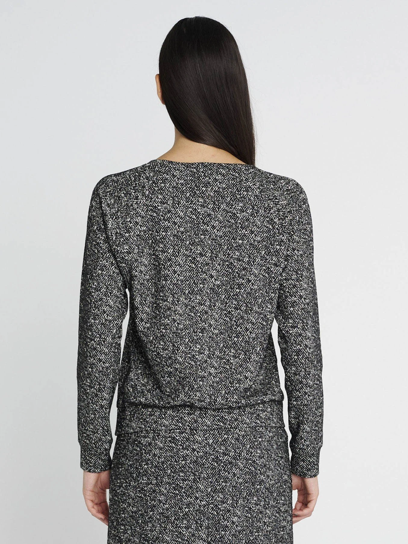 Langärmliger Sweater mit Gummi-Bündchen und rundem Ausschnitt in schwarz/ weiß meliert.
