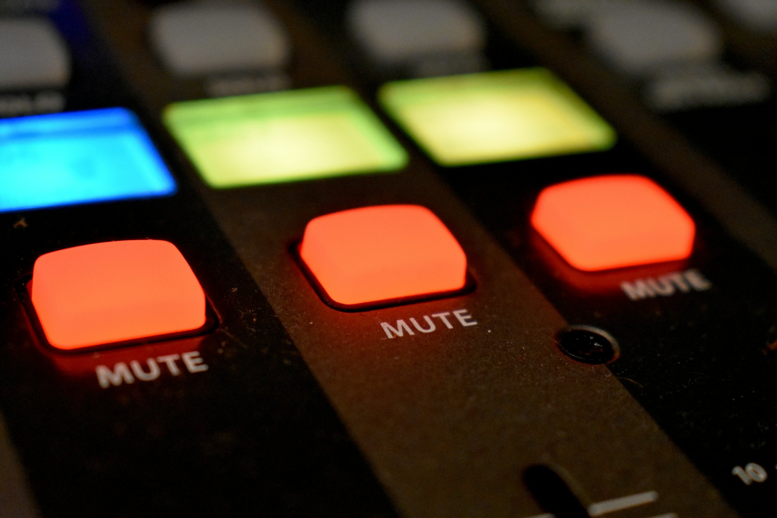 Mute buttons on a control board.