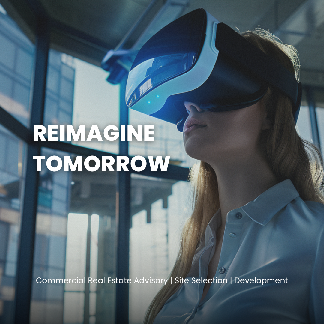 A woman wearing a virtual reality headset in a modern office or industrial space with large windows and natural light. The text on the image says 'Reimagine Tomorrow' and 'Commercial Real Estate Advisory | Site Selection | Development.'