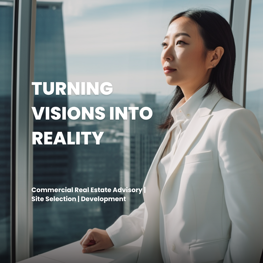 A professional woman in a white suit looks out of a high-rise window at a cityscape with tall buildings and blue sky. The text on the image reads 'Turning Visions into Reality' and 'Commercial Real Estate Advisory | Site Selection | Development'.