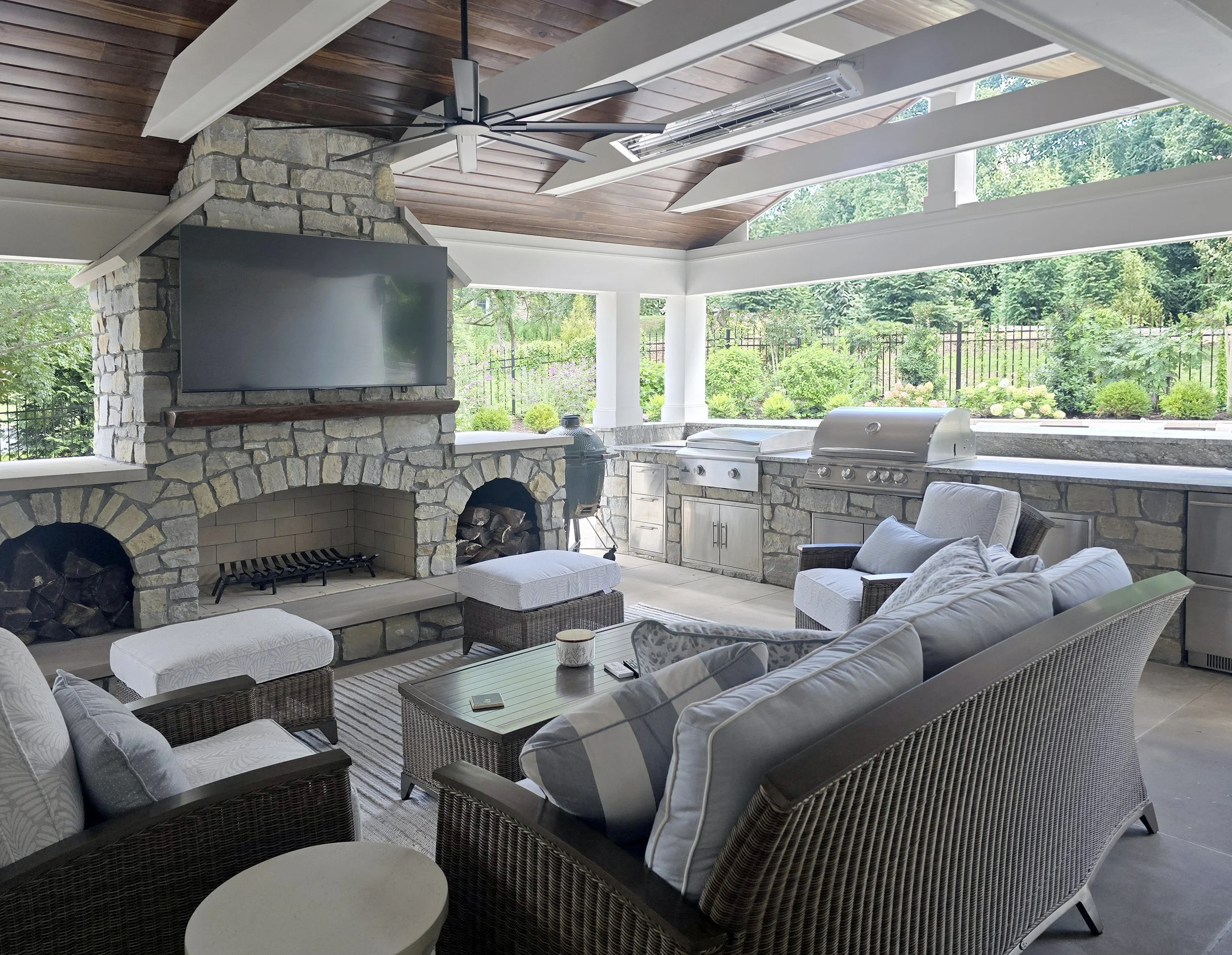 Outdoor fireplace, wood burning fireplace, outdoor kitchen, green egg, Blackstone Griddle, large format limestone pavers, tongue & grove ceiling, infrared heaters, ceiling fan