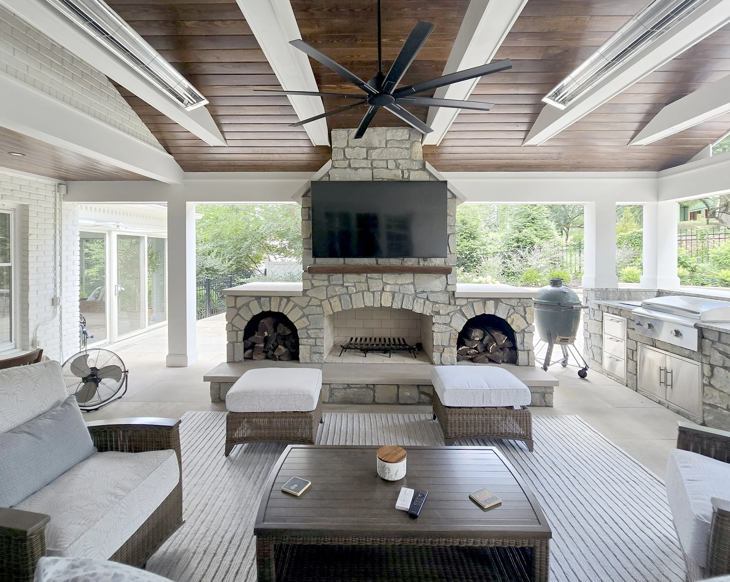 Outdoor fireplace, wood burning fireplace, outdoor kitchen, green egg, Blackstone Griddle, large format limestone pavers, tongue & grove ceiling, infrared heaters, ceiling fan